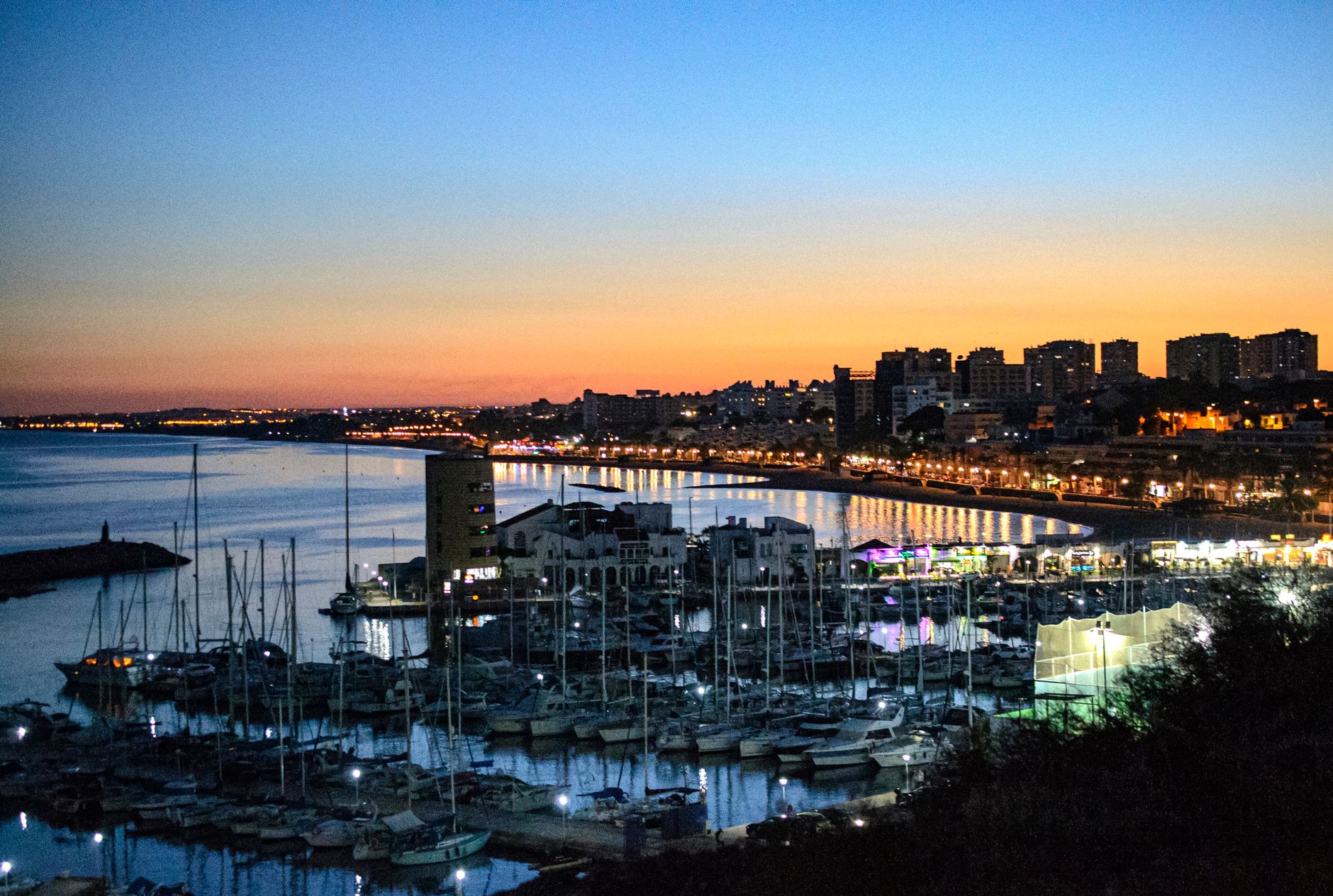 A marina at dusk with slips, service lanes, and shoreline infrastructure that reflects the kind of spread-out property this buyer guide discusses.