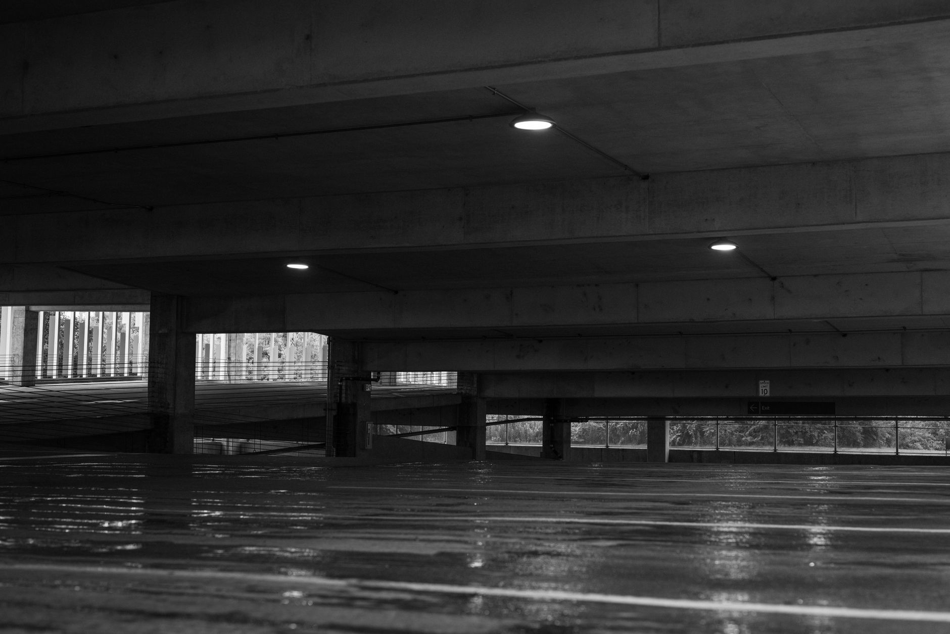A lit parking garage entrance on a healthcare campus, a common alarm verification point for overnight patrol.