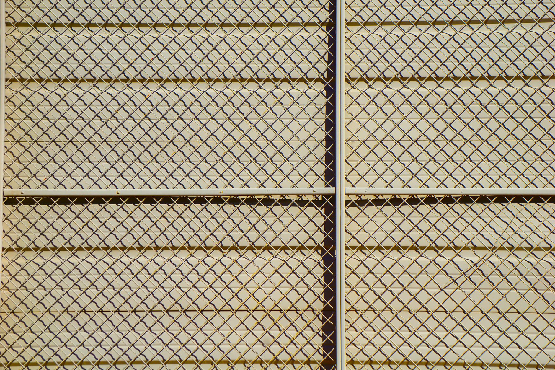 Chain-link perimeter fencing and open industrial grounds at dusk, matching the kind of large outdoor campus discussed in the buyer guide.