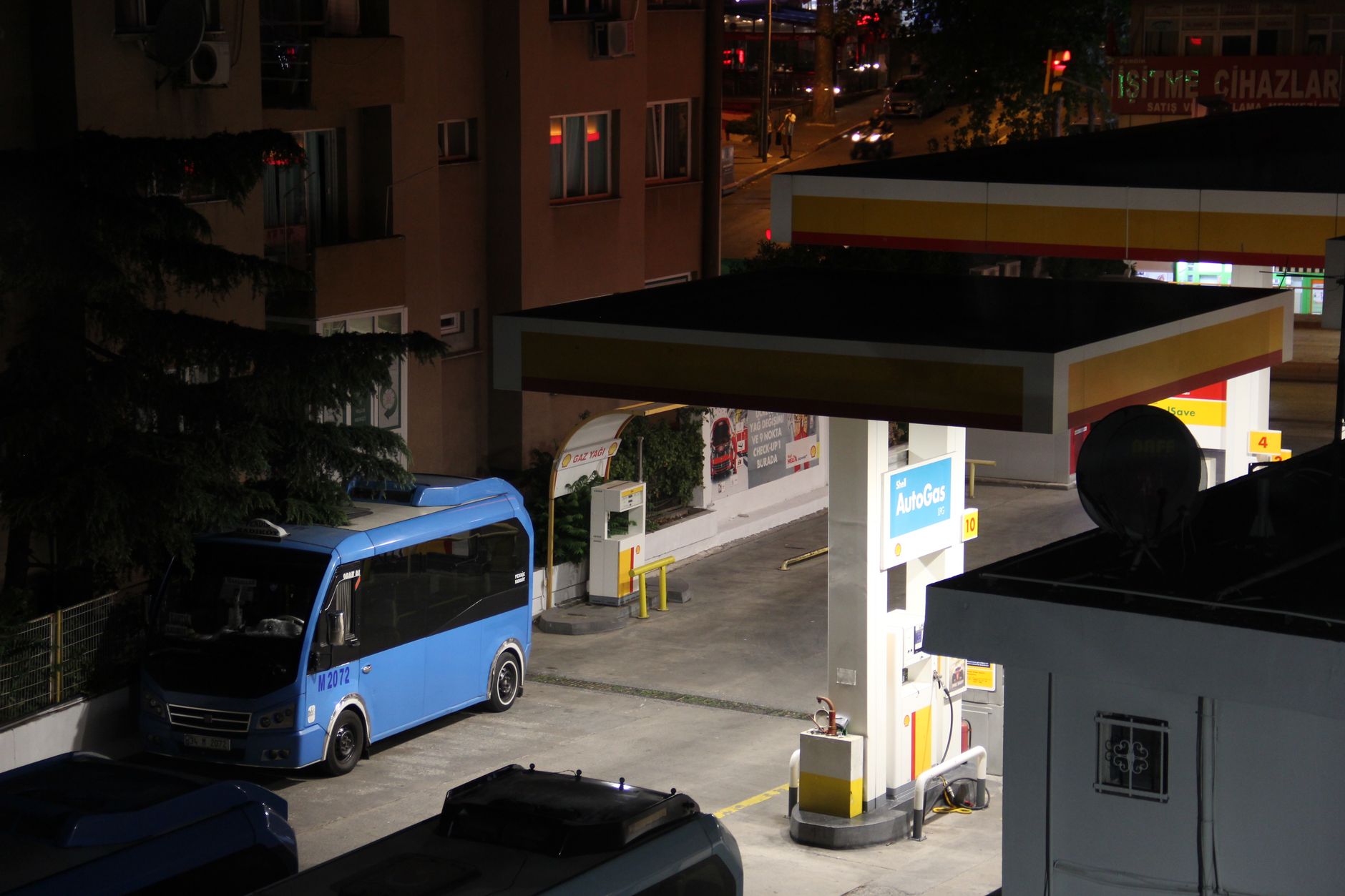 A transit bus fueling area with pumps, hoses, and safety clearances, illustrating why patrol routes near fueling zones must respect hazardous work areas.