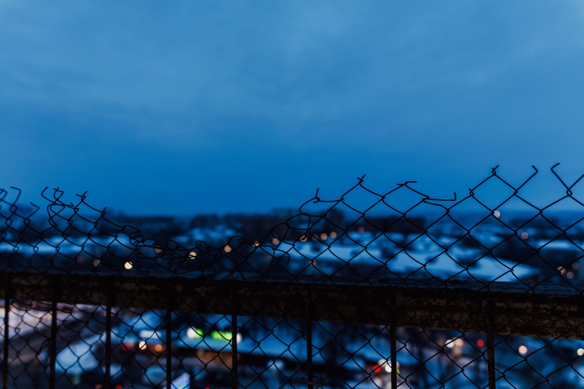 A long fence line at night with glare and patchy lighting, matching the low-visibility conditions where thermal, low-light video, and navigation reliability matter.