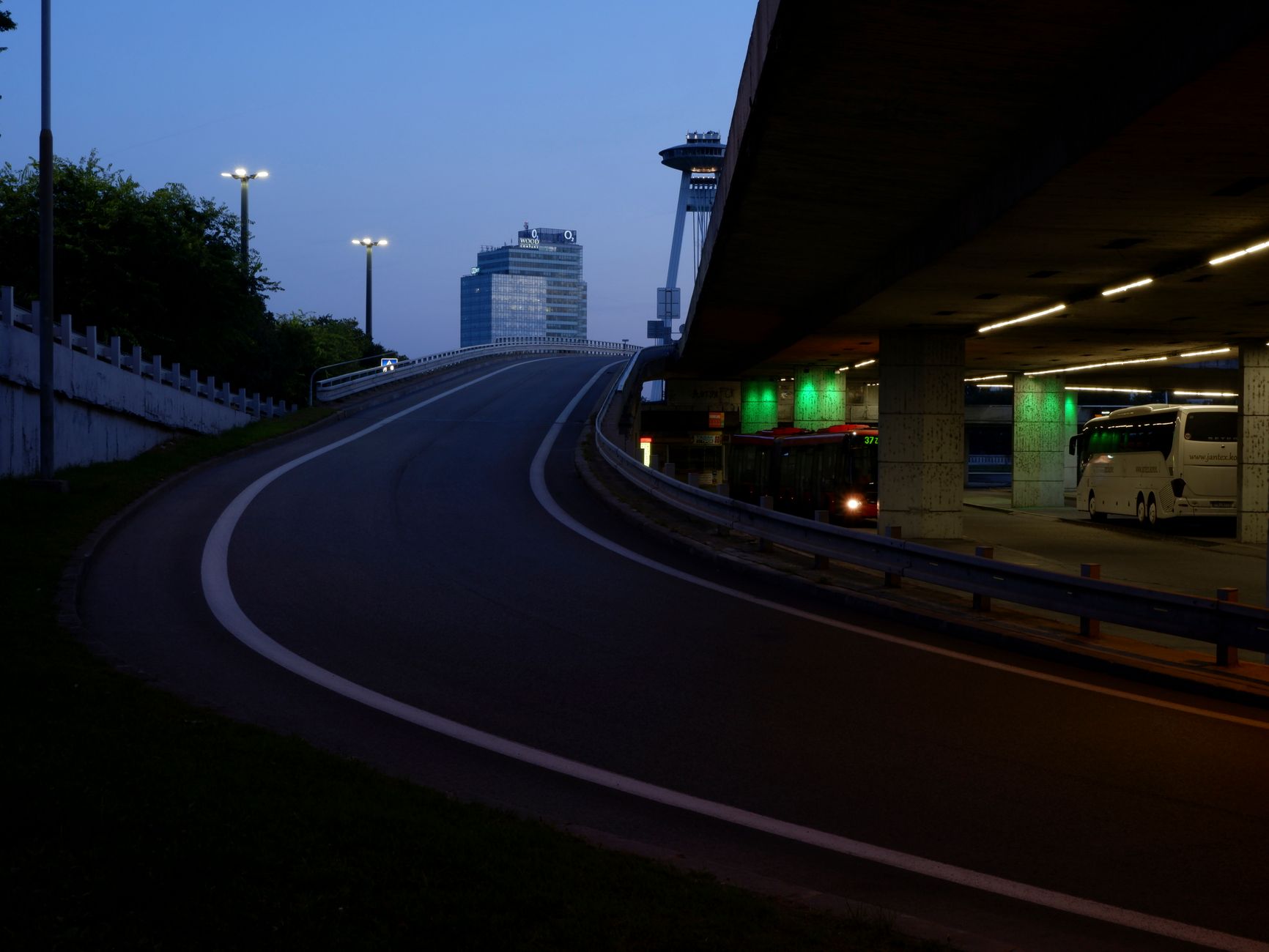 Rows of parked transit buses in a dimly lit depot at night, showing the large after-hours environment where mobile patrols add visibility.