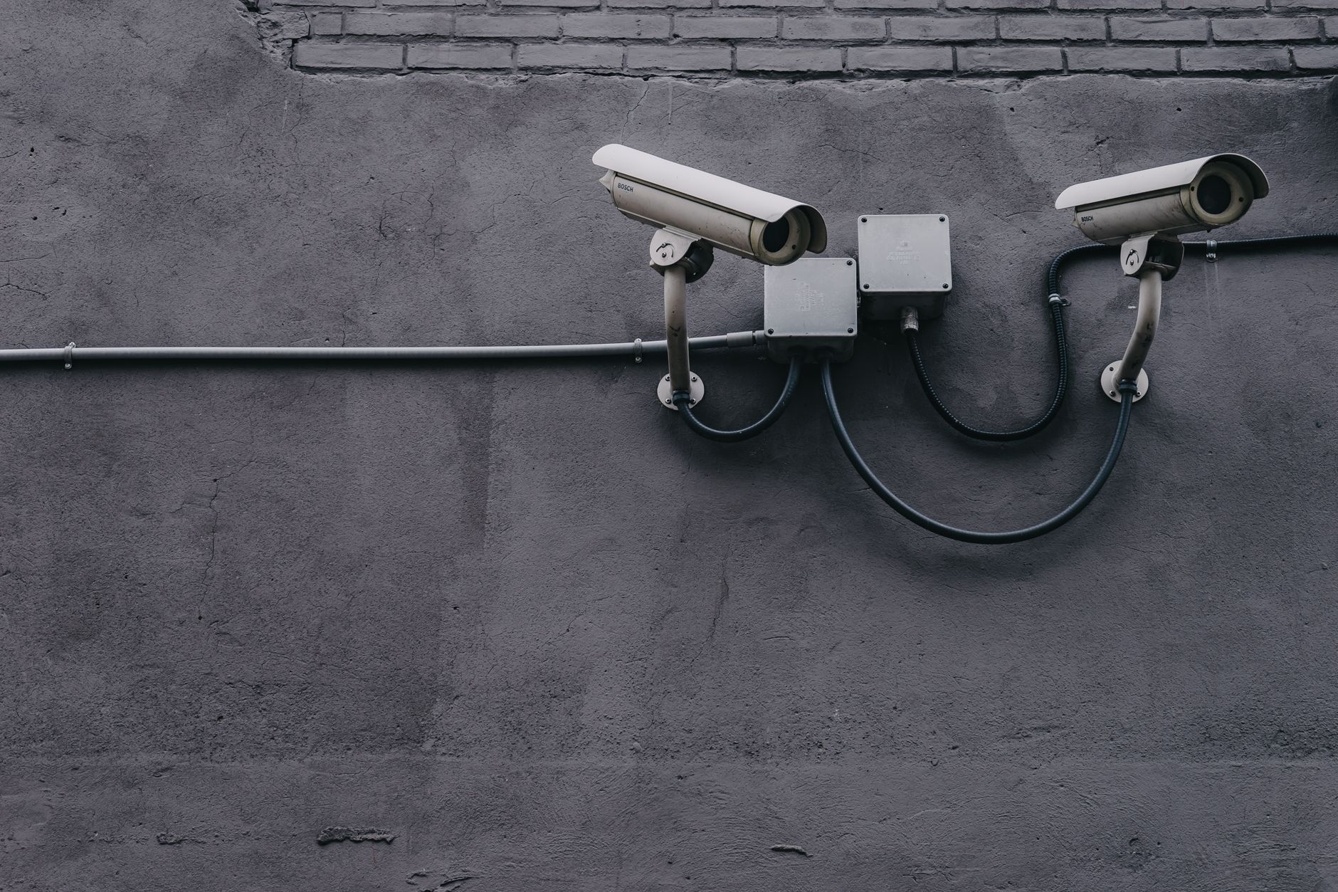 An outdoor security camera overlooks a parking area after dark.
