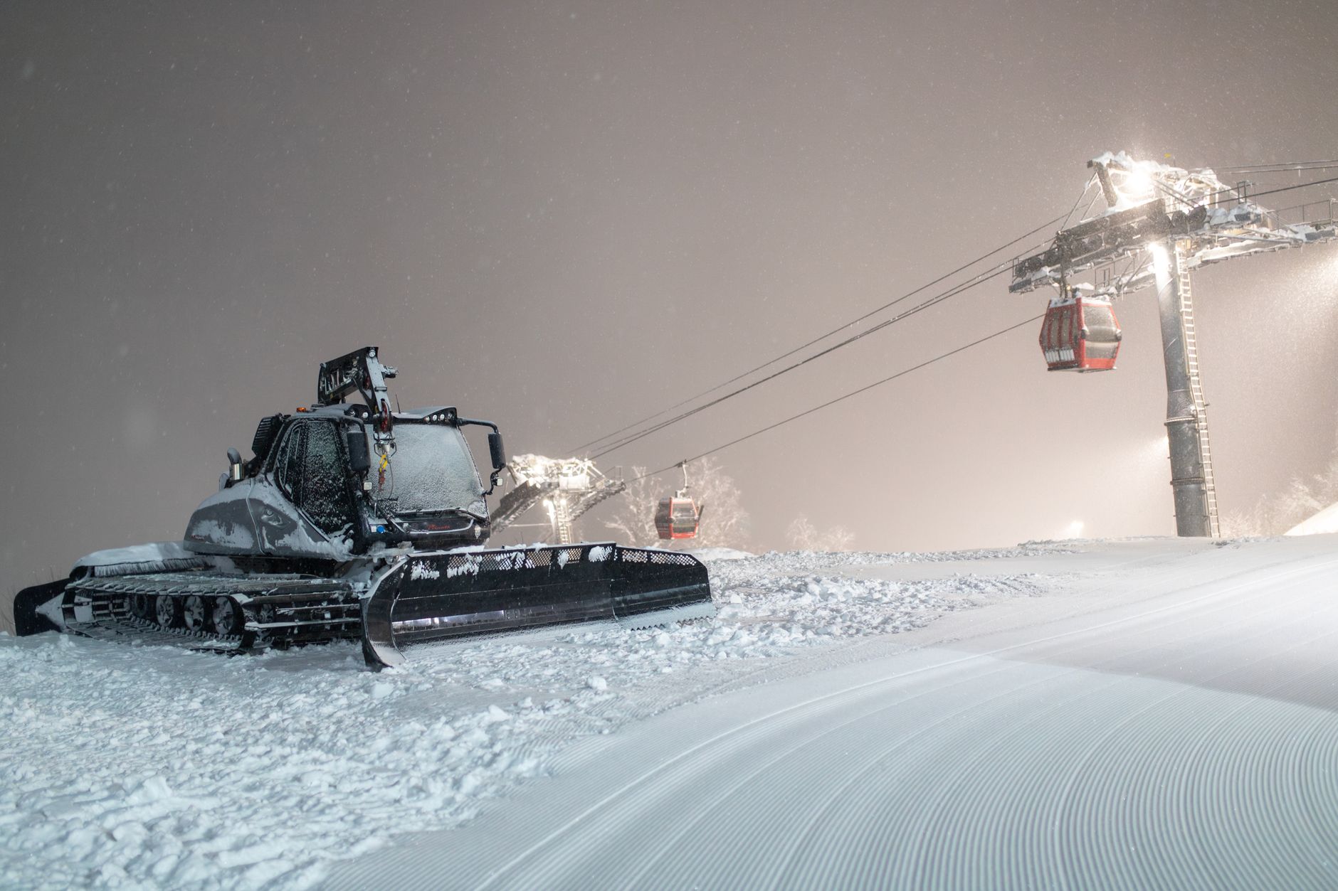 Maintenance workers service ski resort equipment during the winter operating season.