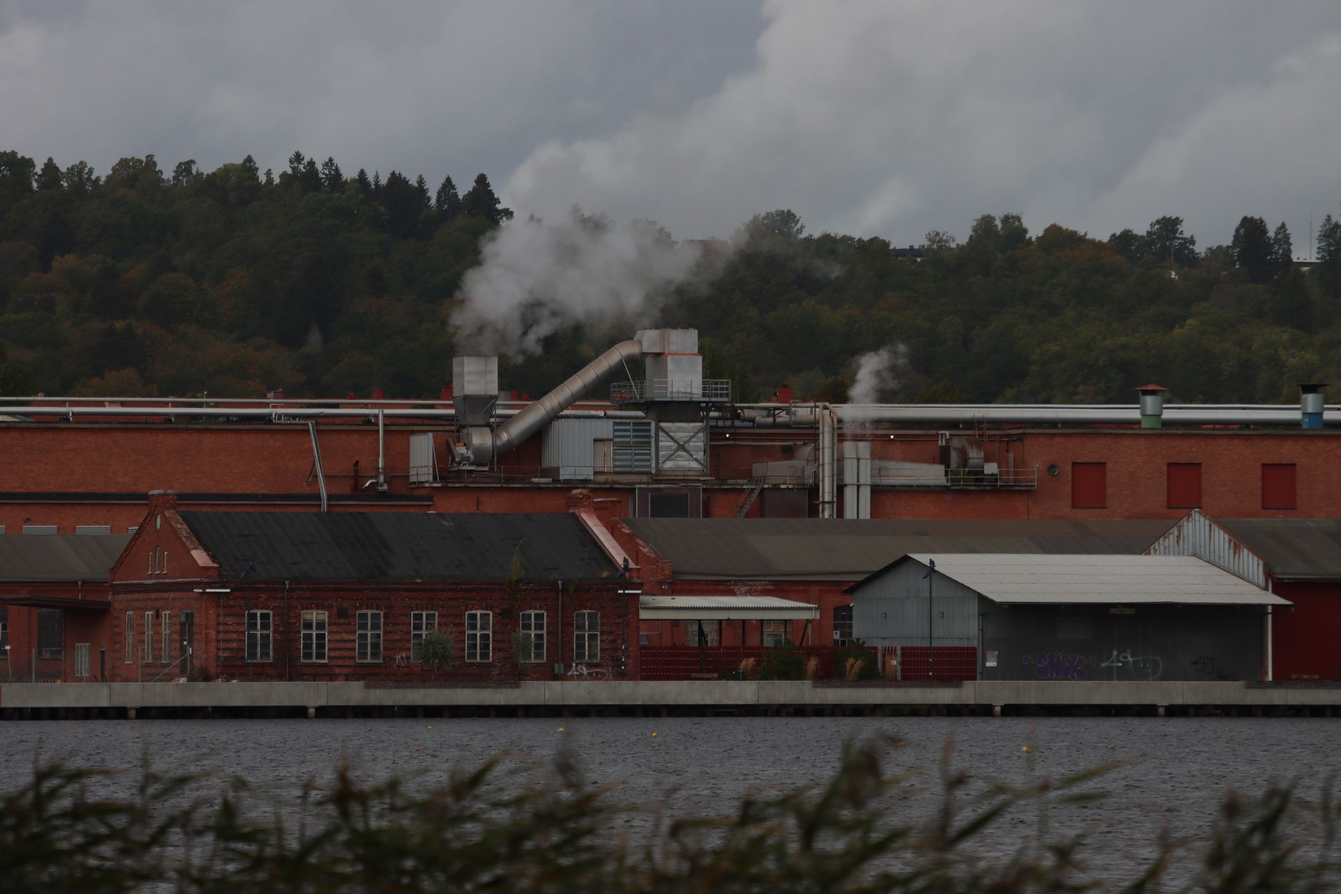 An industrial building at night where early heat detection matters near stored combustible waste.