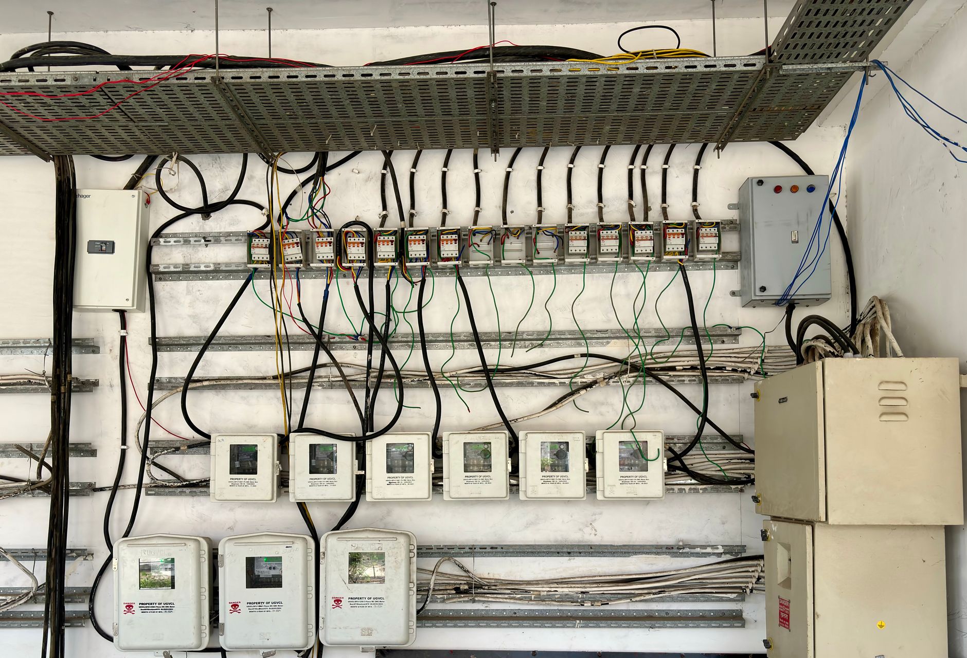 A detailed close-up of an open electrical panel with complex, colorful wiring, illustrating a critical asset that an inspection robot would monitor for thermal anomalies.