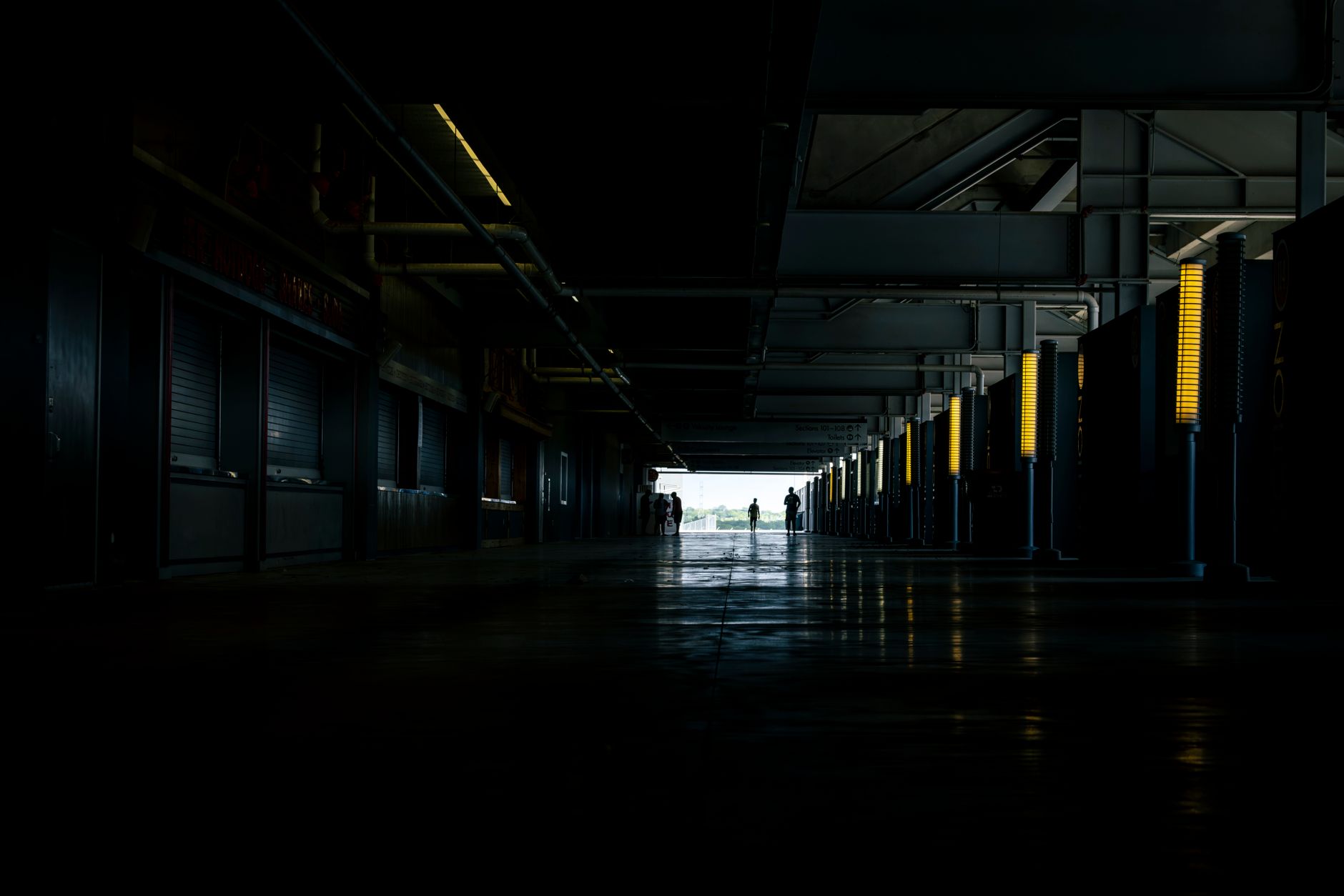 A long, empty, and well-lit corridor in a modern building, representing the kind of extended patrol route a security robot would navigate.