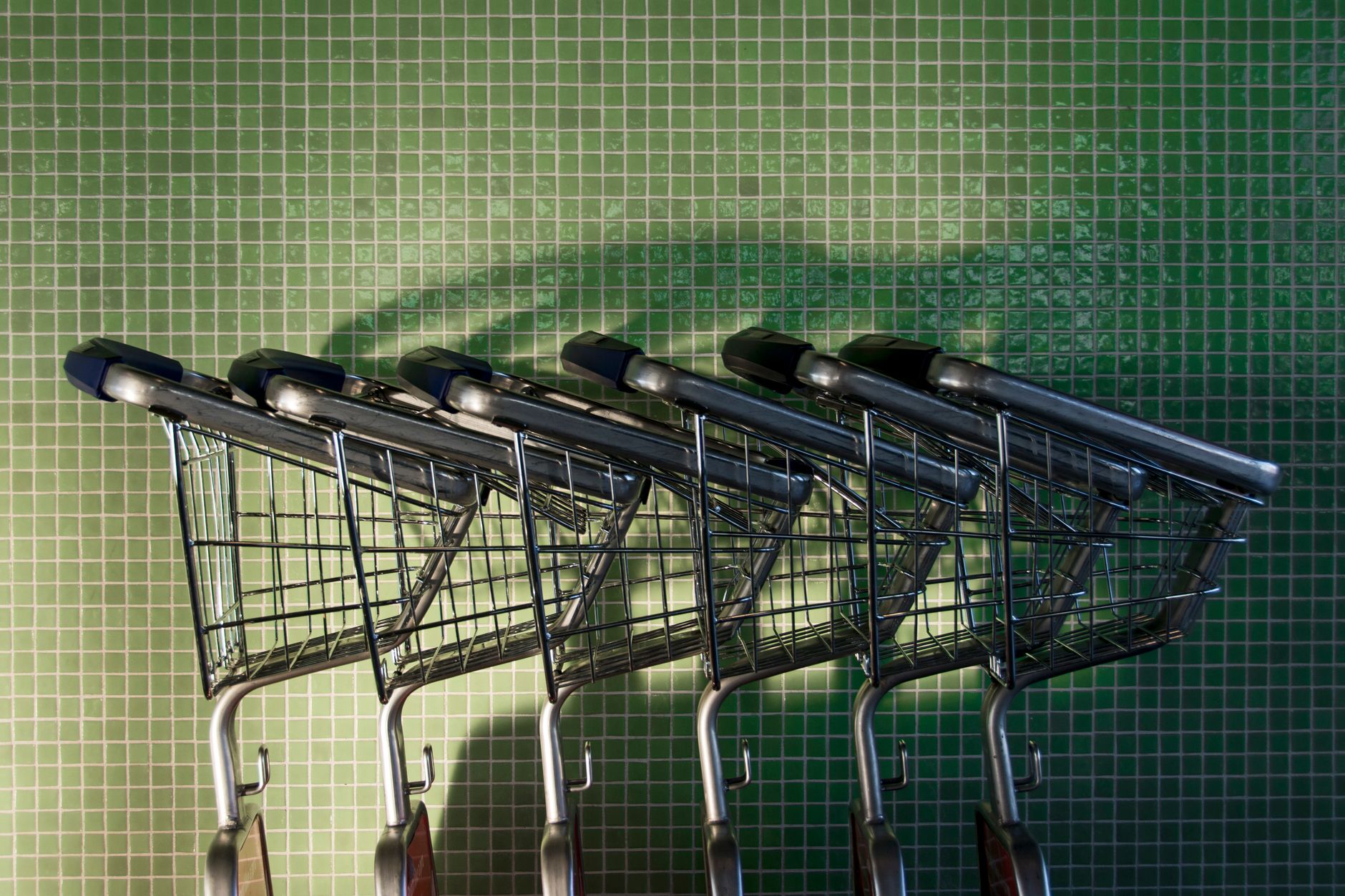 Grocery aisle flooring that shows spills and cart wear throughout the day.