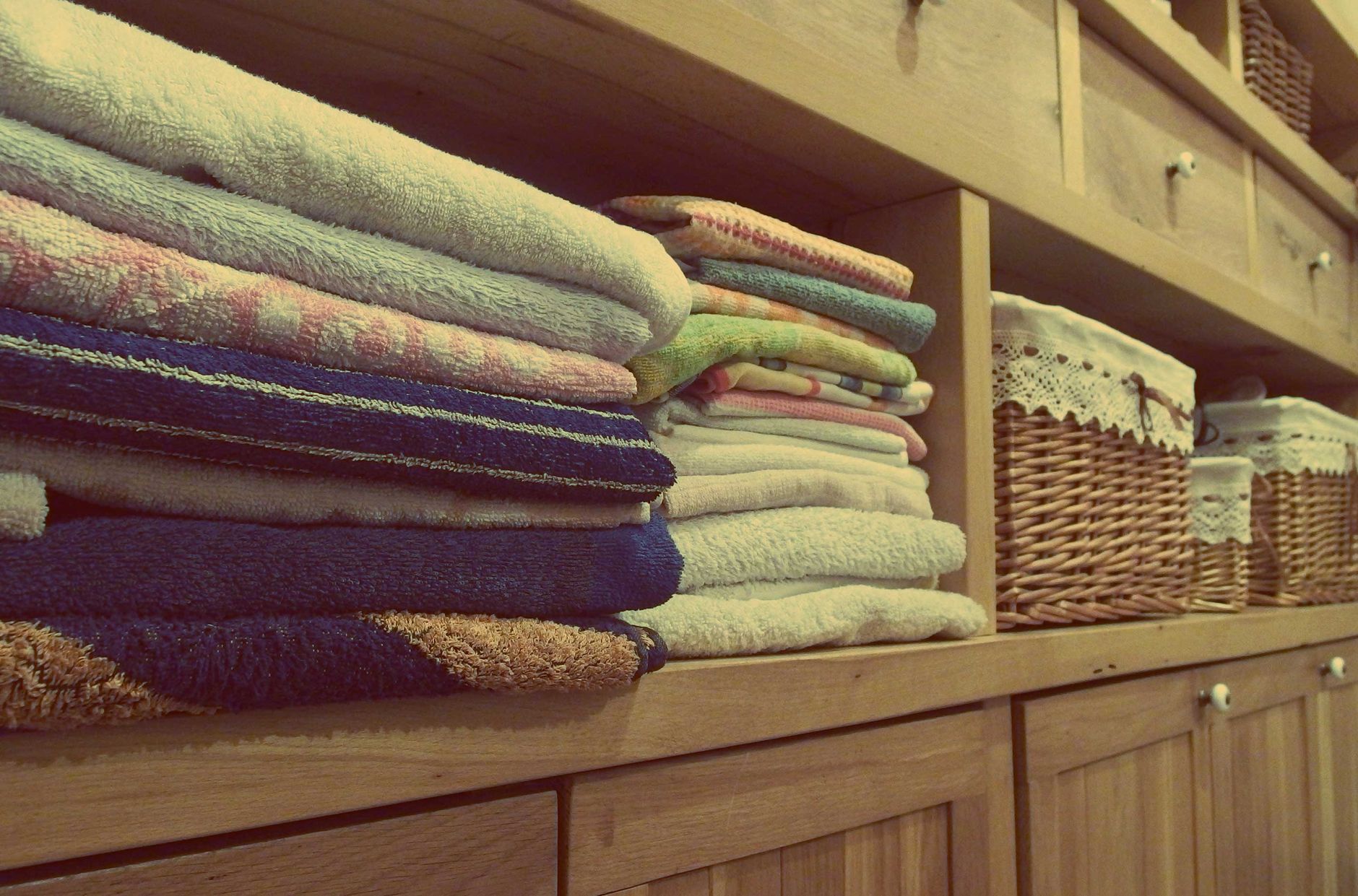 Shelved clean linens in a care setting, reinforcing the article’s focus on controlled, separated laundry flows.