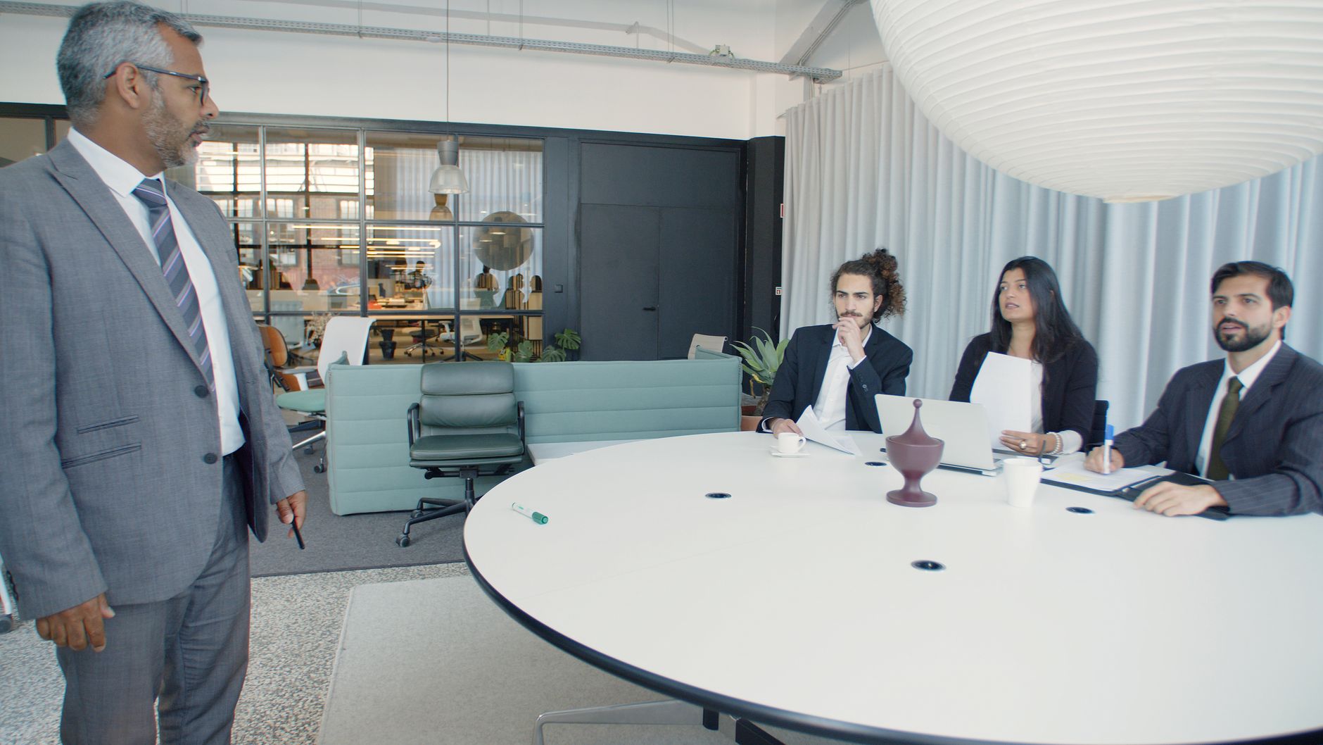 Team meeting in a conference room where pilot results are reviewed for stakeholder approval.
