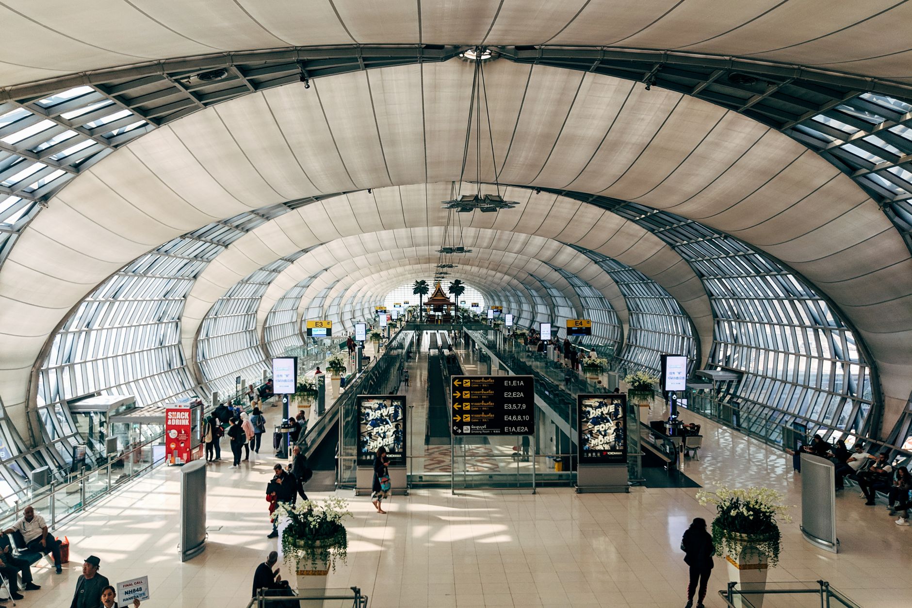 A busy airport concourse with long sightlines and heavy pedestrian traffic, reflecting a site where fast spill detection matters.