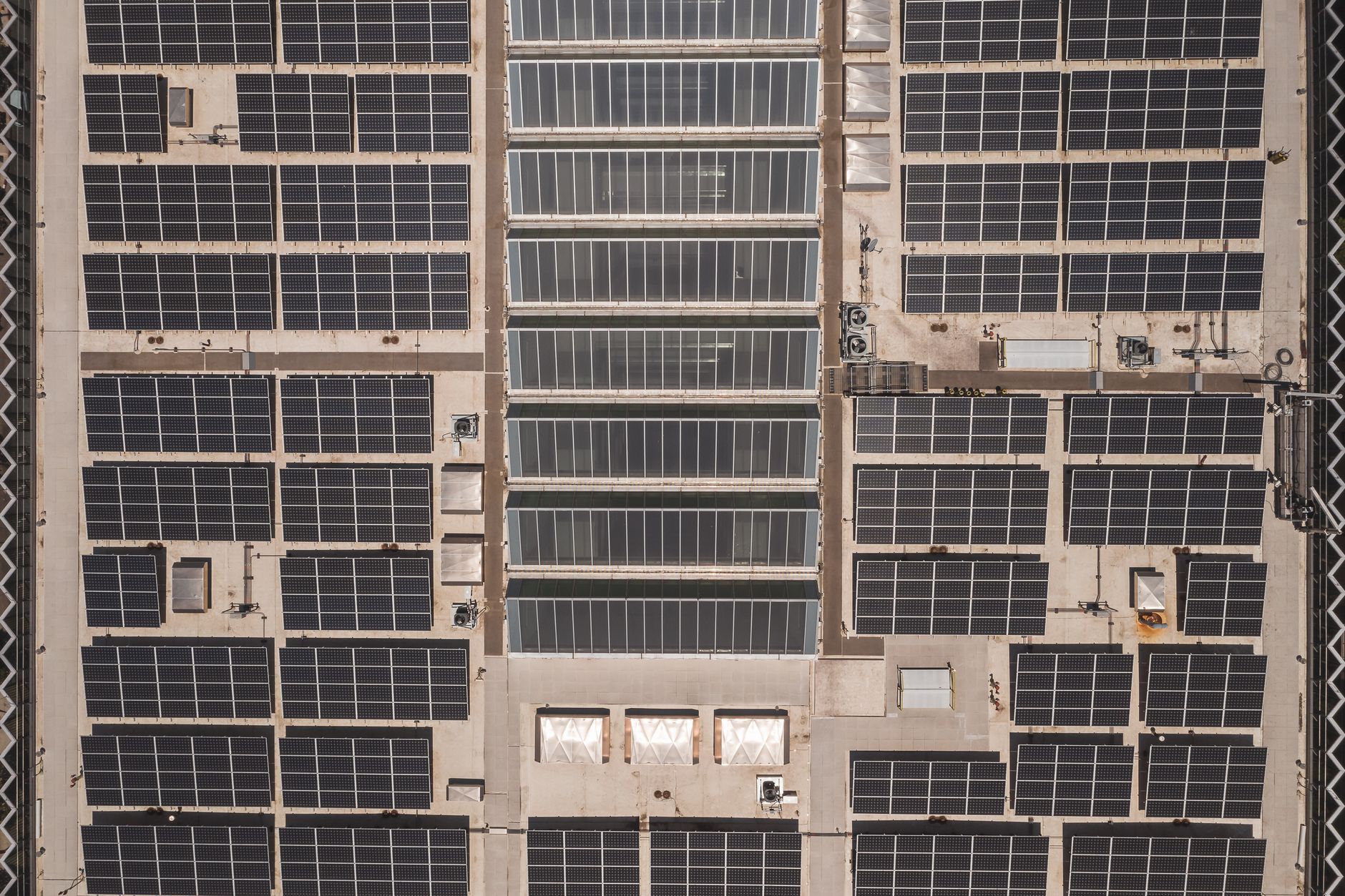 Solar panels mounted on an outdoor structure under a cloudy sky.