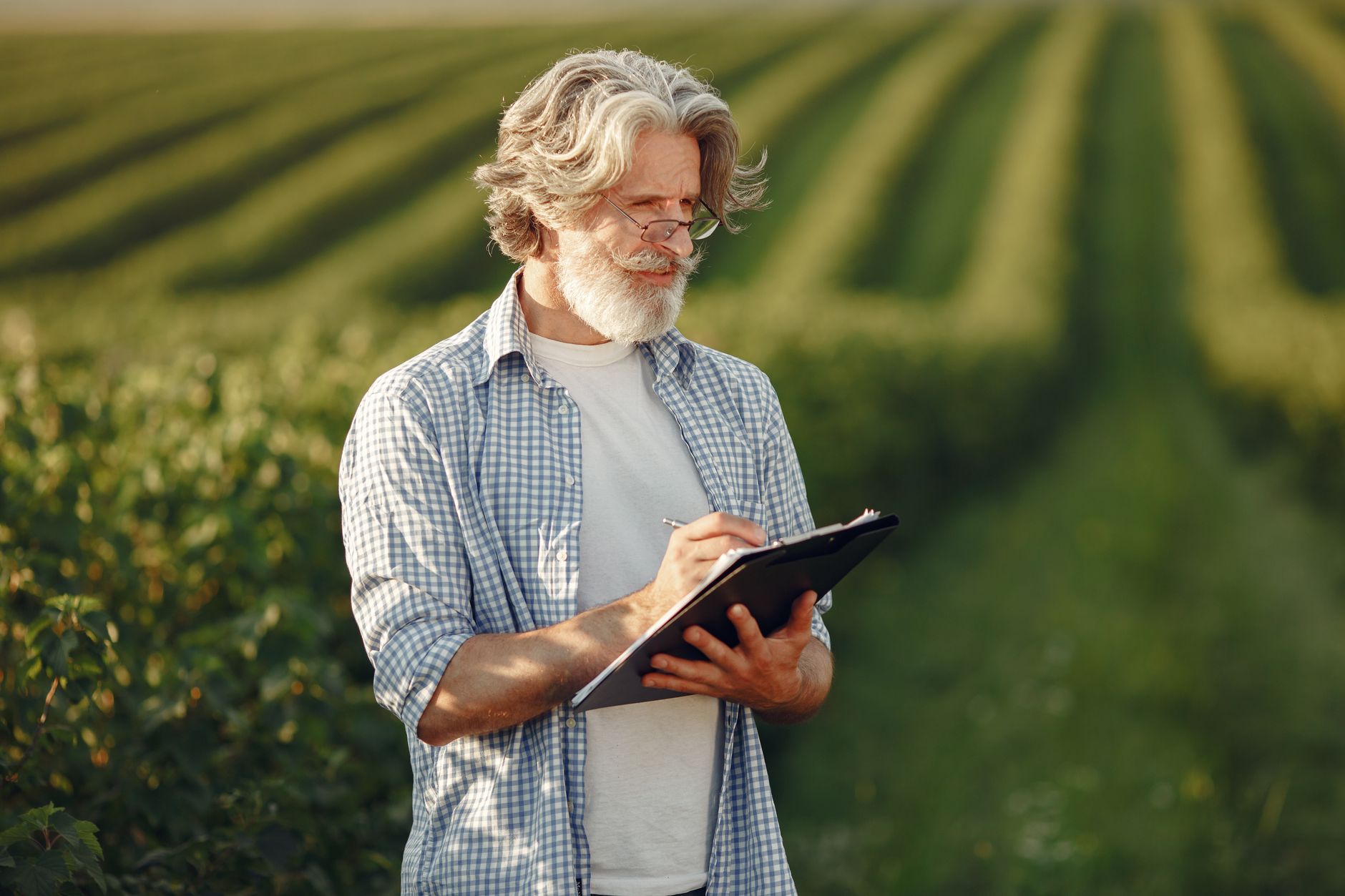 Applicator reviewing a spray log on a clipboard