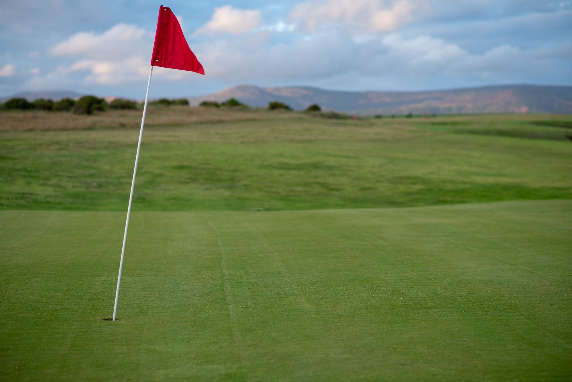 Flag on a windy golf course fairway