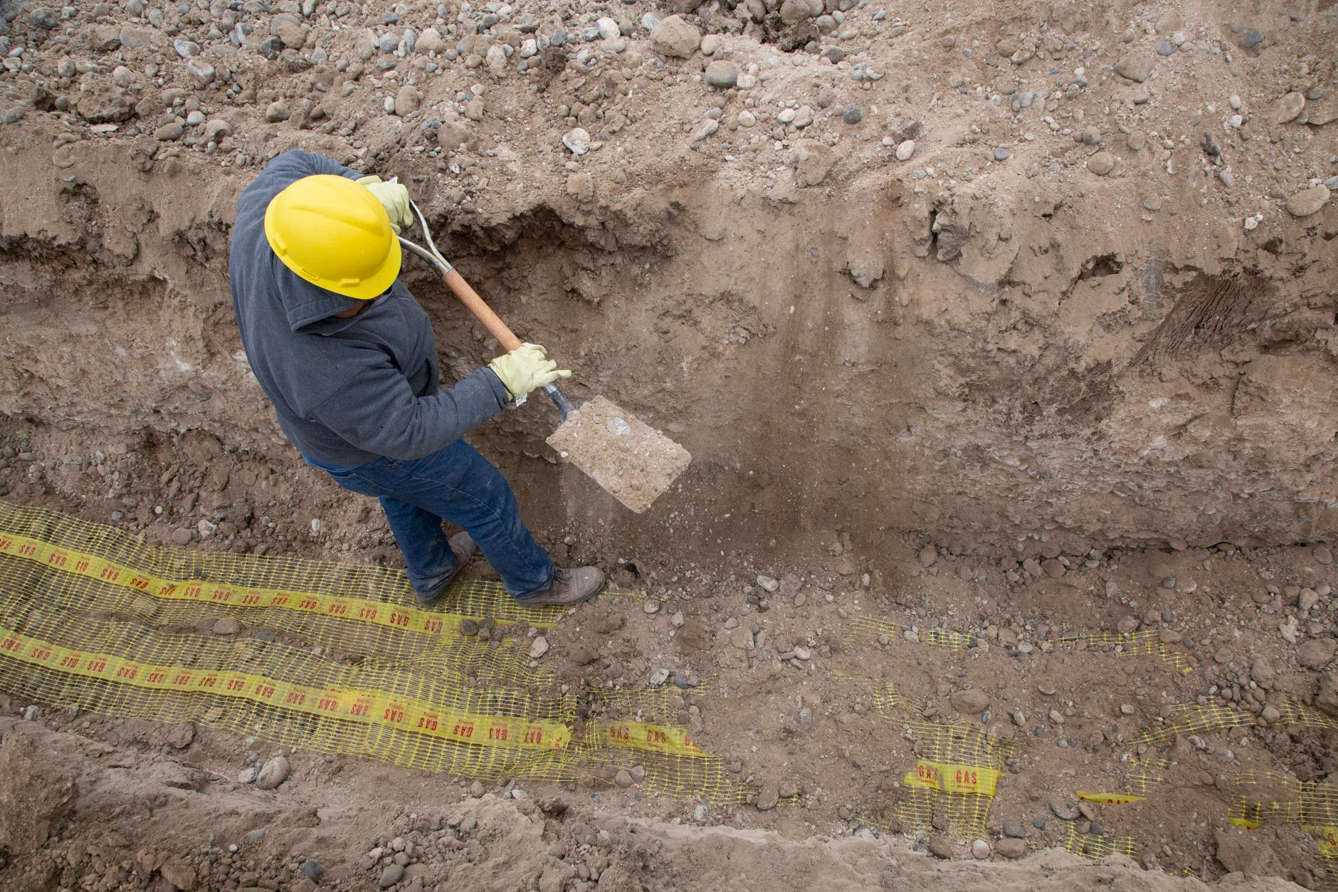 An open trench line across turf during irrigation repair