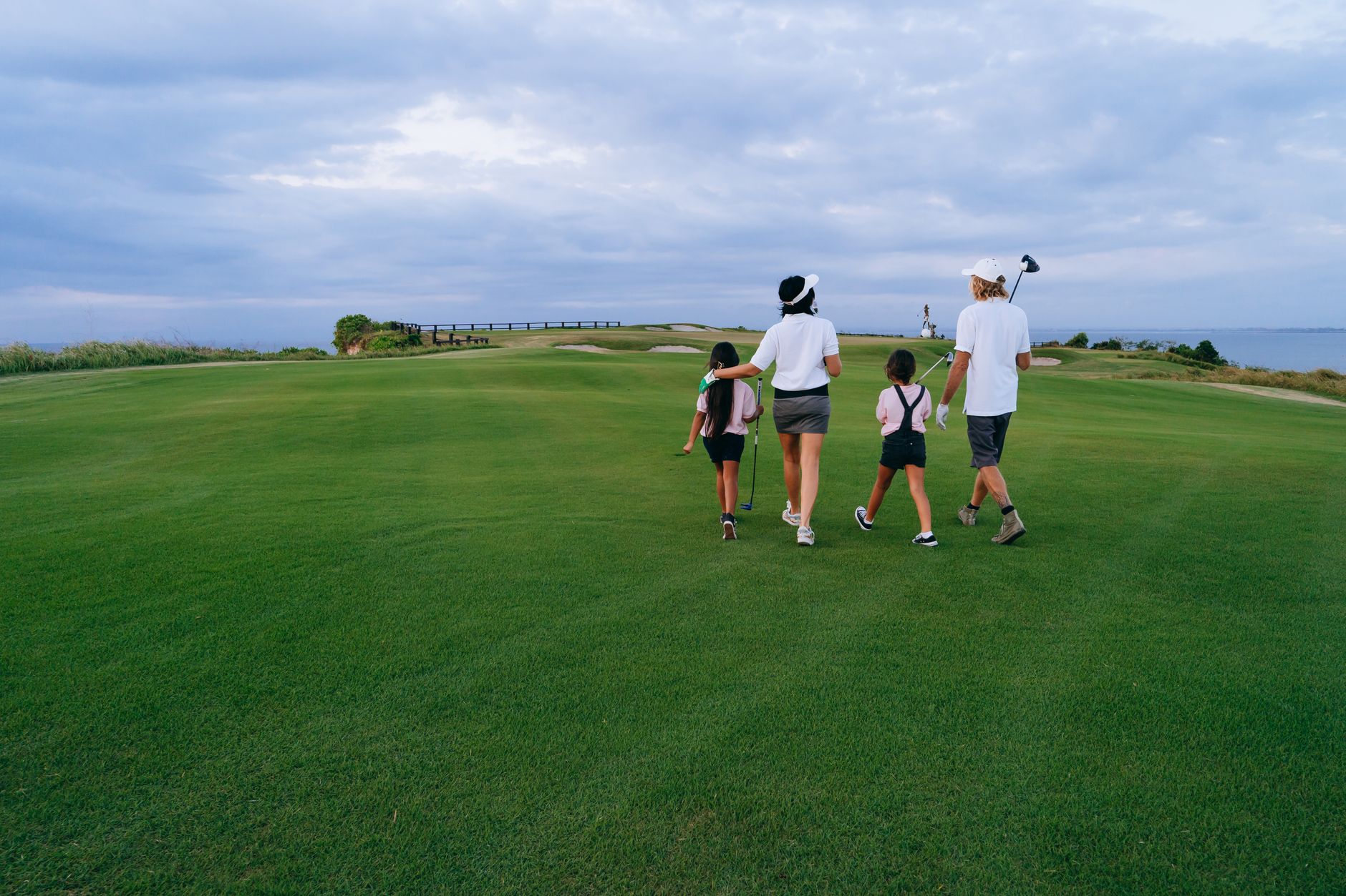 A foursome on a fairway during competitive Sunday play.