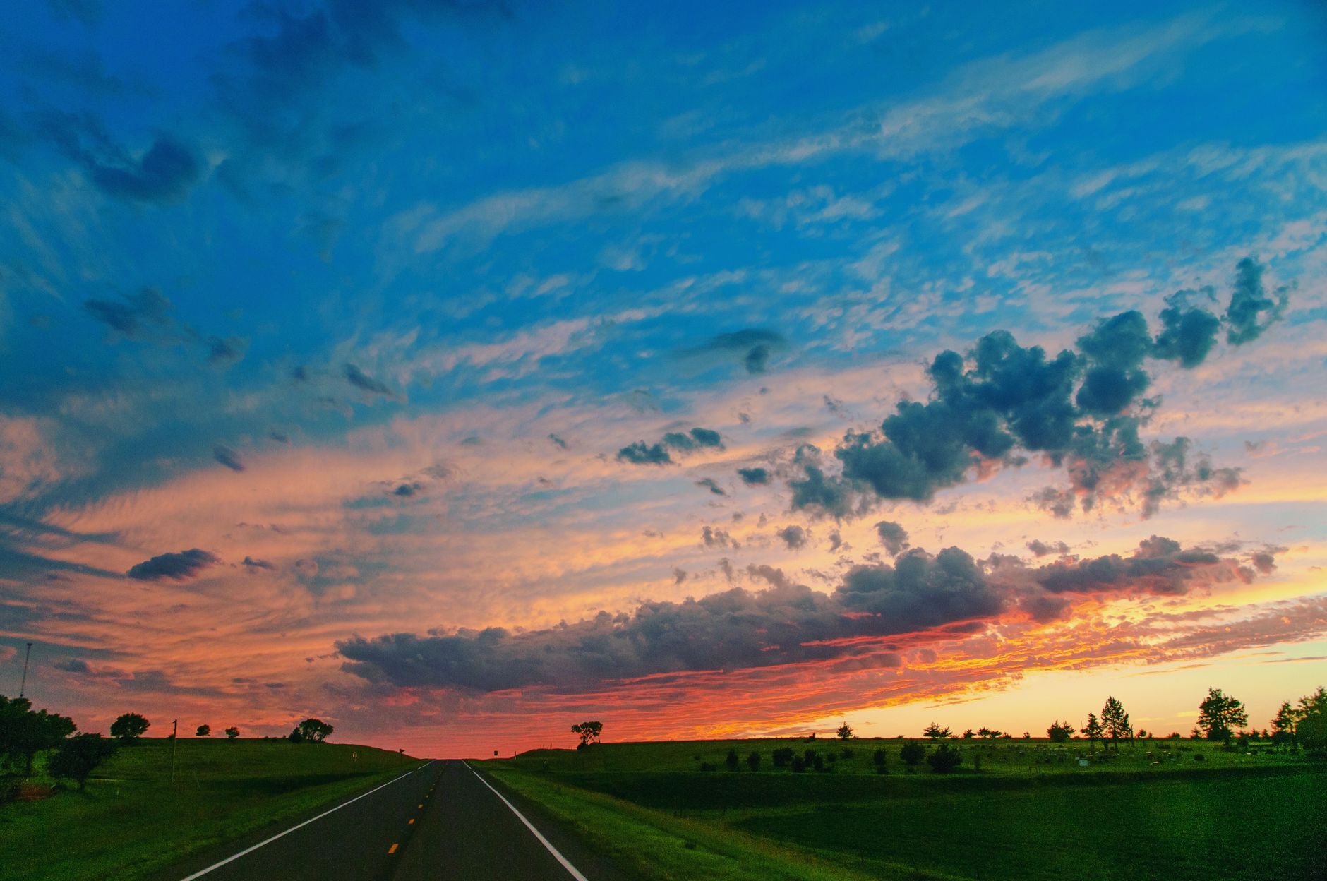 Rural highway across open farmland at dusk