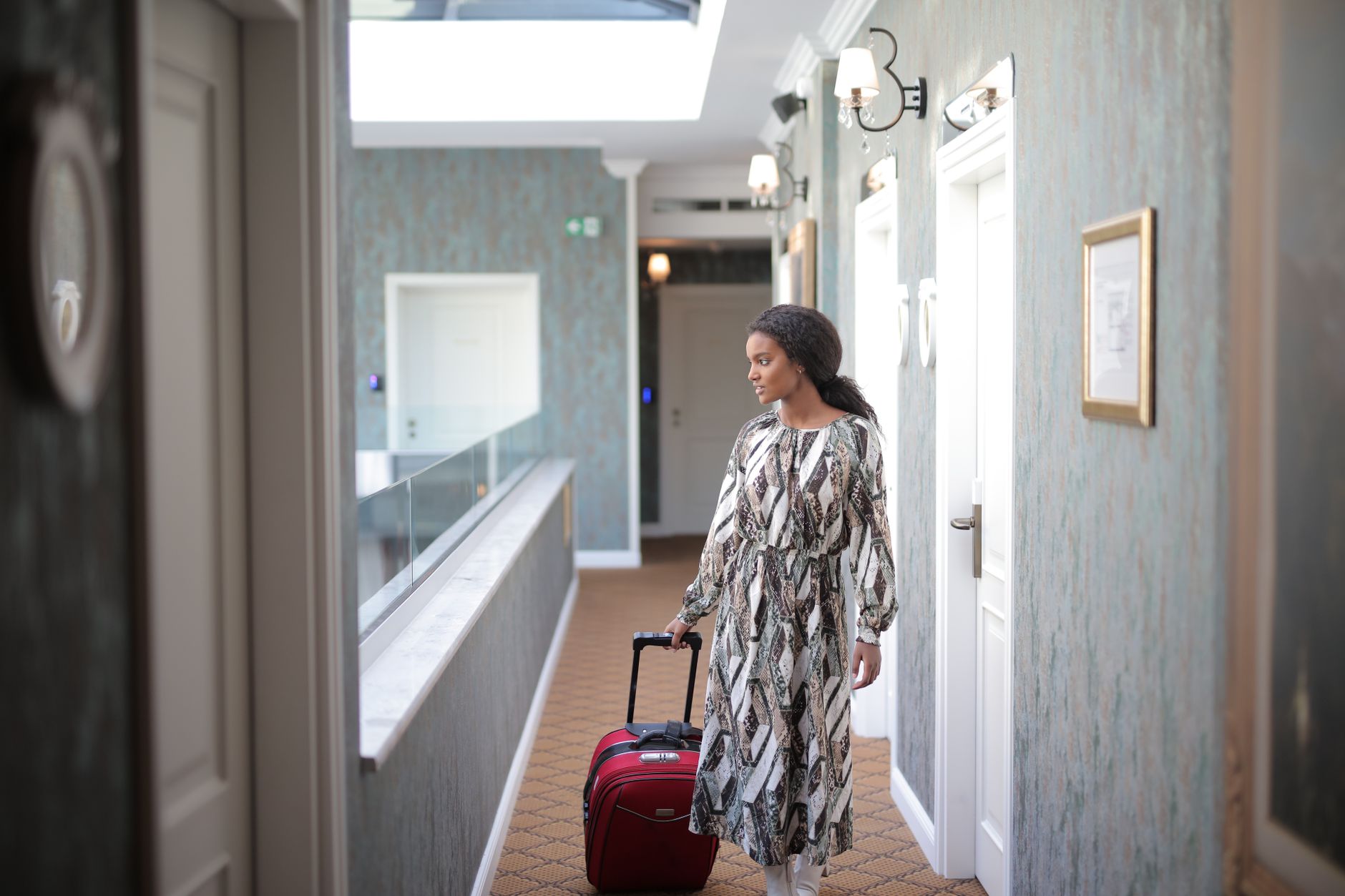 Luggage occupying a hotel corridor shows how temporary obstacles can disrupt a planned cleaning path.