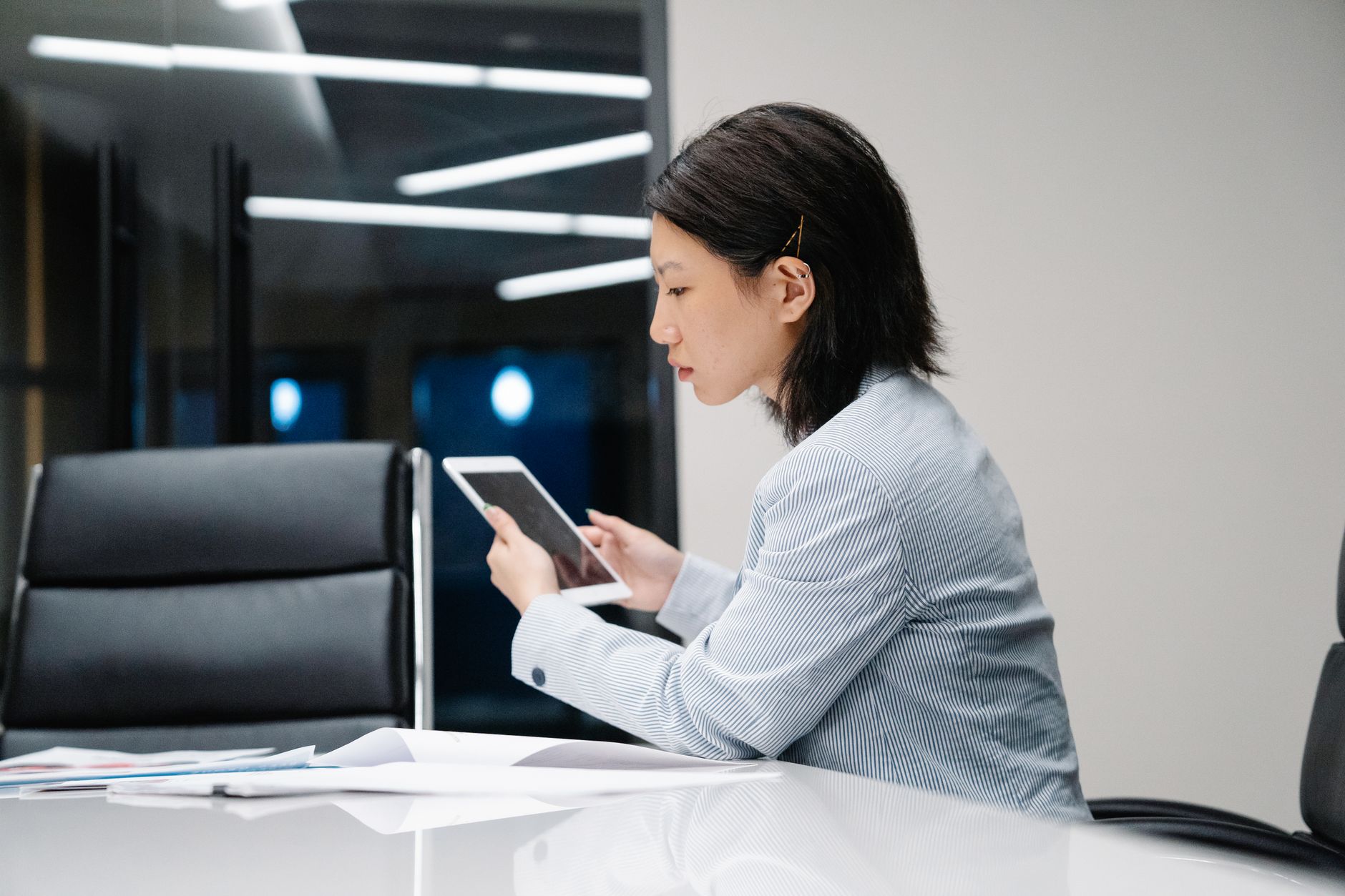 A facility manager reviewing a tablet represents the mission reports and exception records supervisors need to assess cleaning coverage.