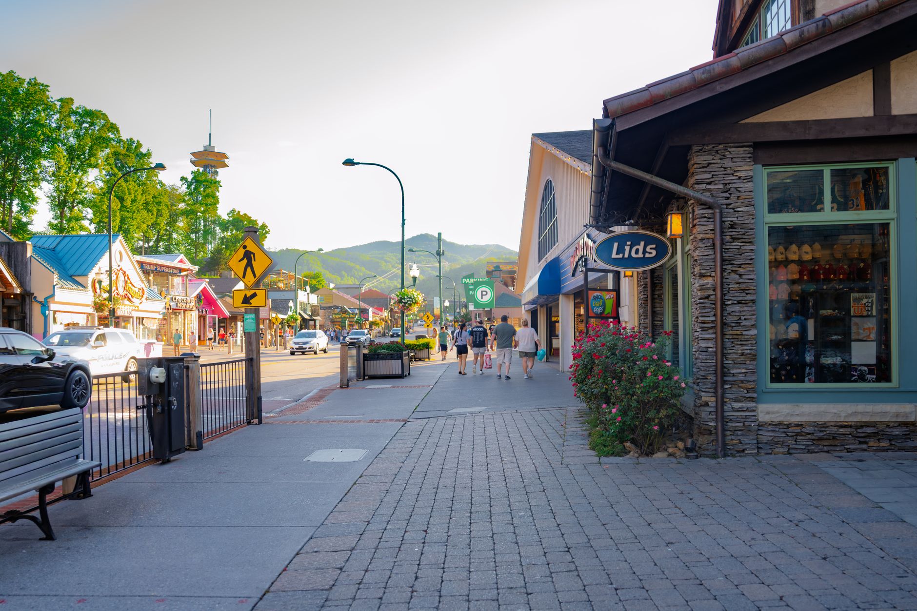 Main street in a mountain town at night with festival lighting