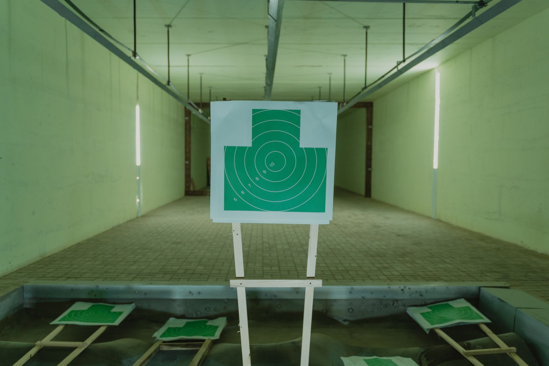 Lobby and retail area at an indoor gun range, representing the cleaner support spaces where a floor-care robot is most useful.