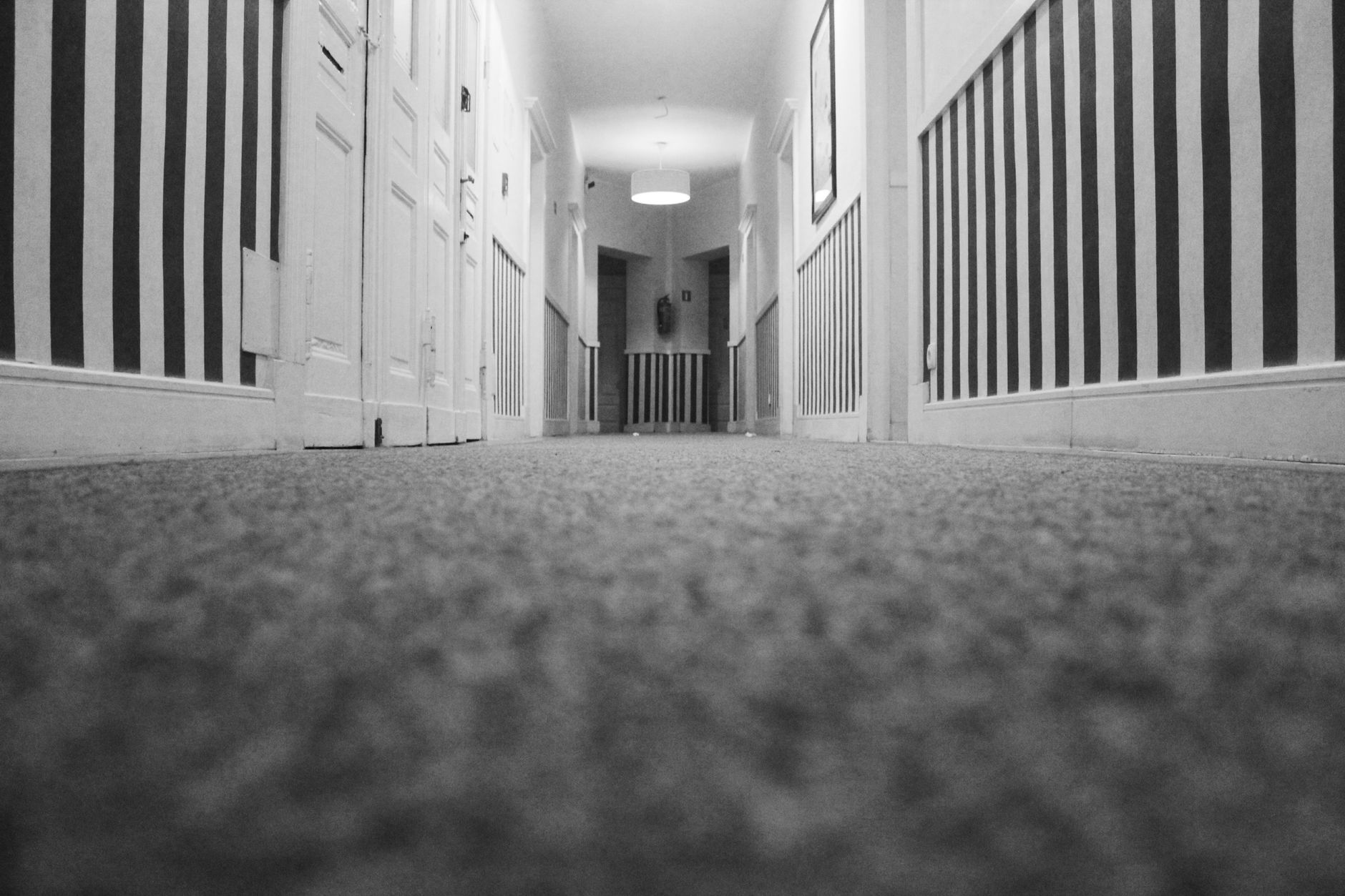 A staff-cleaned hotel corridor with hard floors reflects the overnight floor-care workload that often makes cleaning the first automation buy.