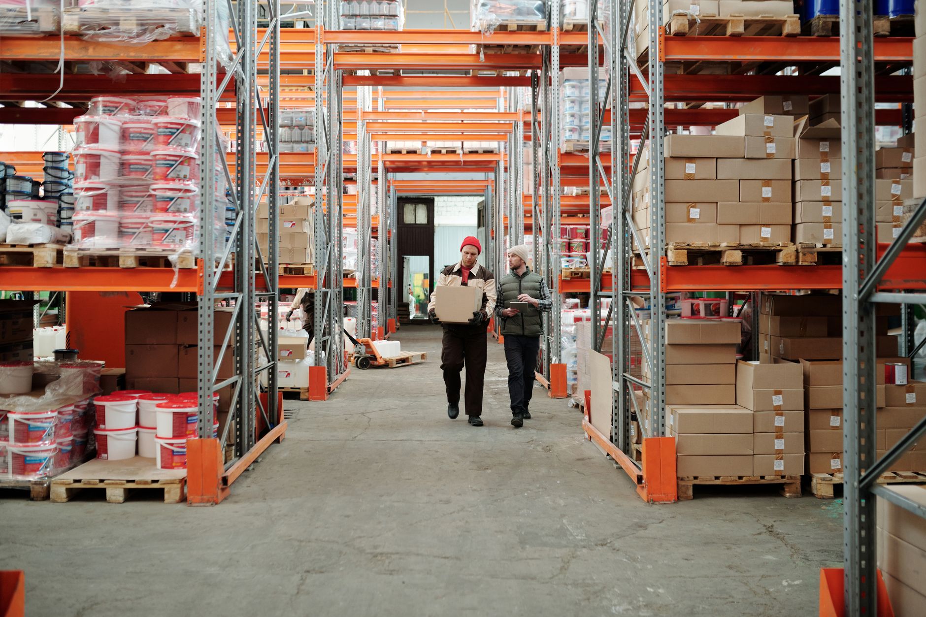 Tall, orderly shelves in a warehouse represent the static, mapped environment a robot uses for global path planning.