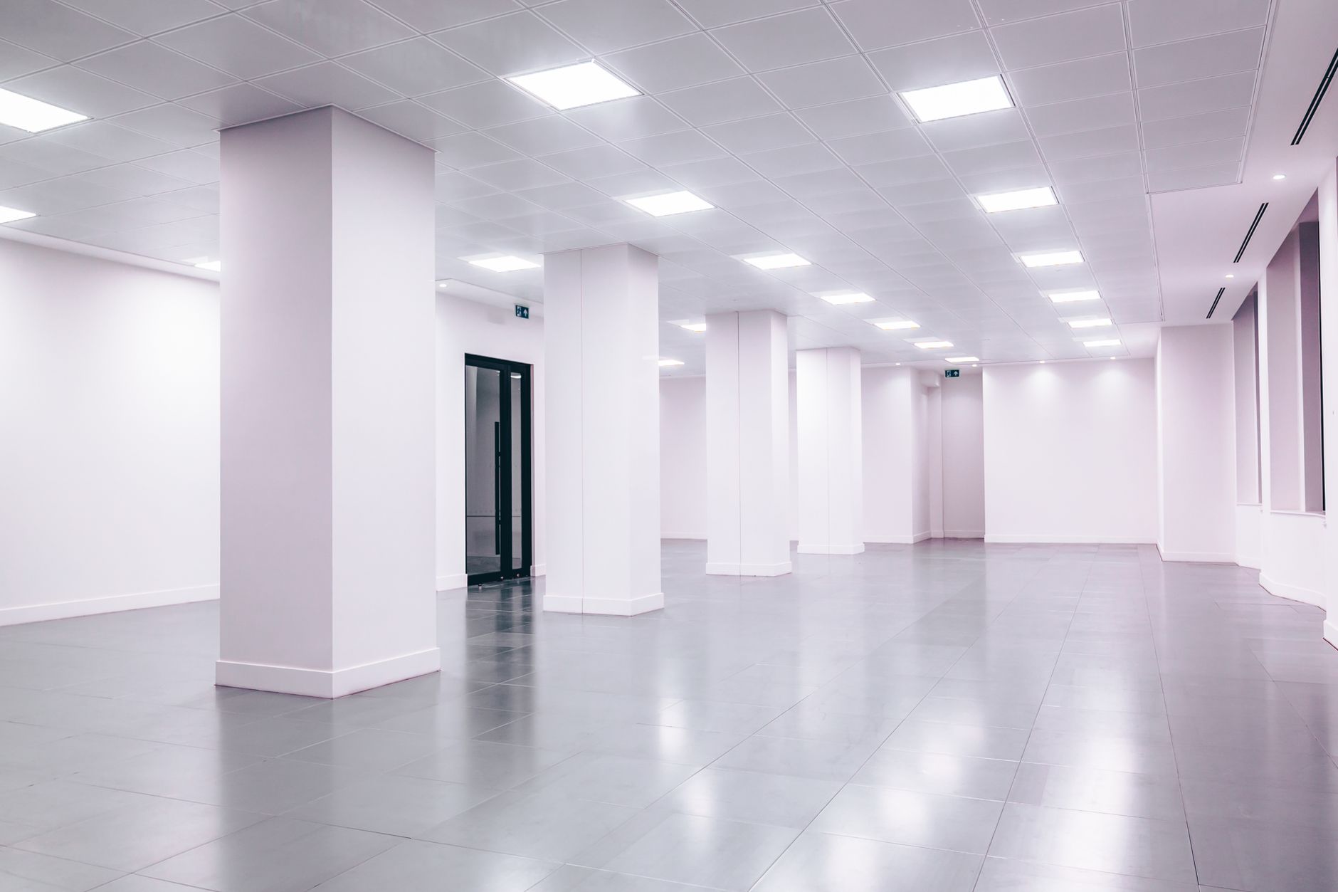 The clean, polished floor of a large commercial space, illustrating an area where a robotic floor cleaner would operate and need property insurance.