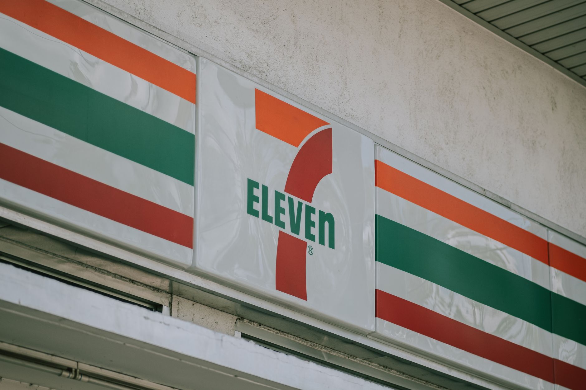 A high-traffic convenience store entrance with mats, glass doors, and heavy drag-in conditions similar to a truck plaza.