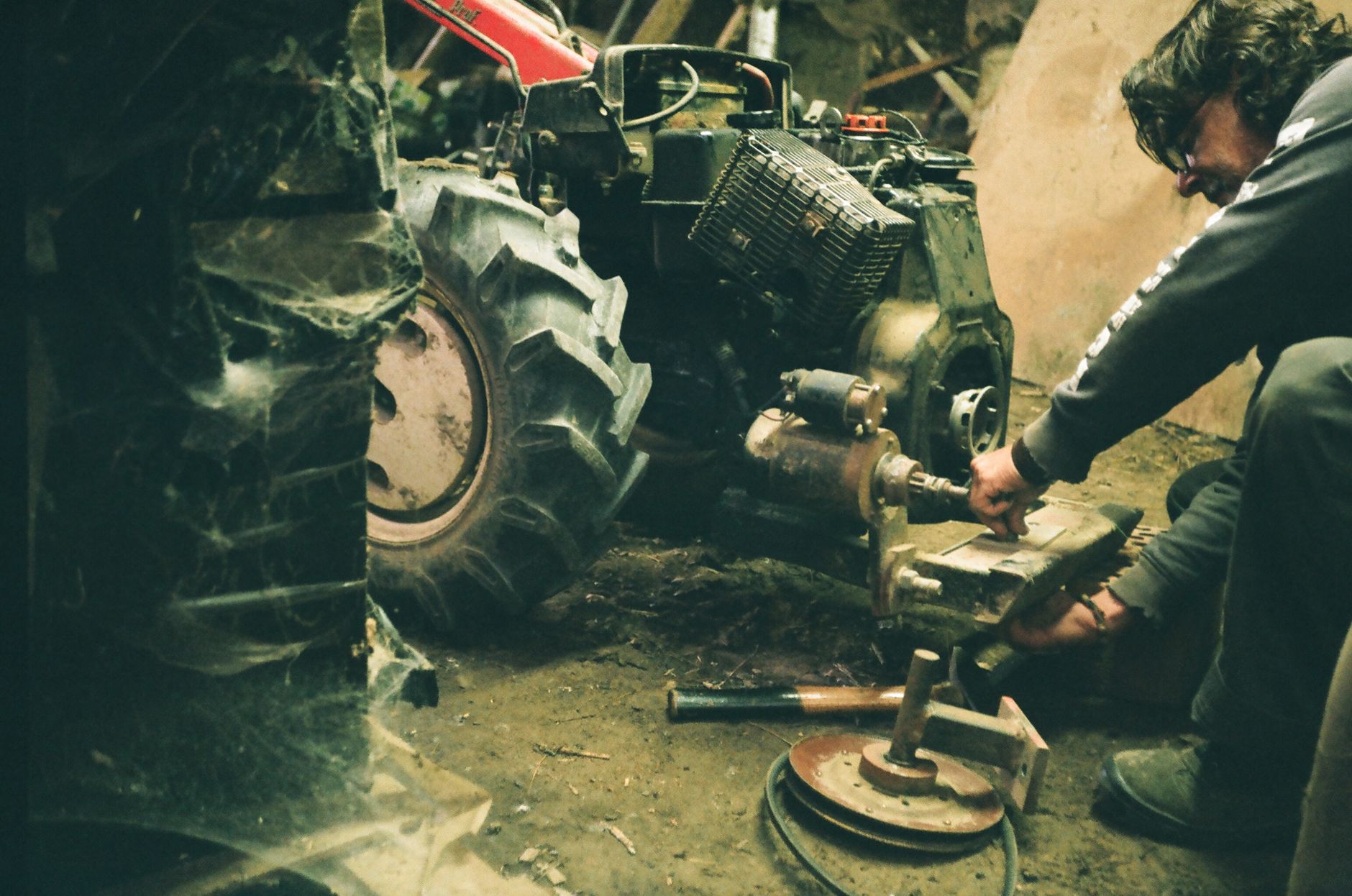 A close-up of dirty, worn machine gears, representing how a small, unaddressed issue can cascade into a major system failure.