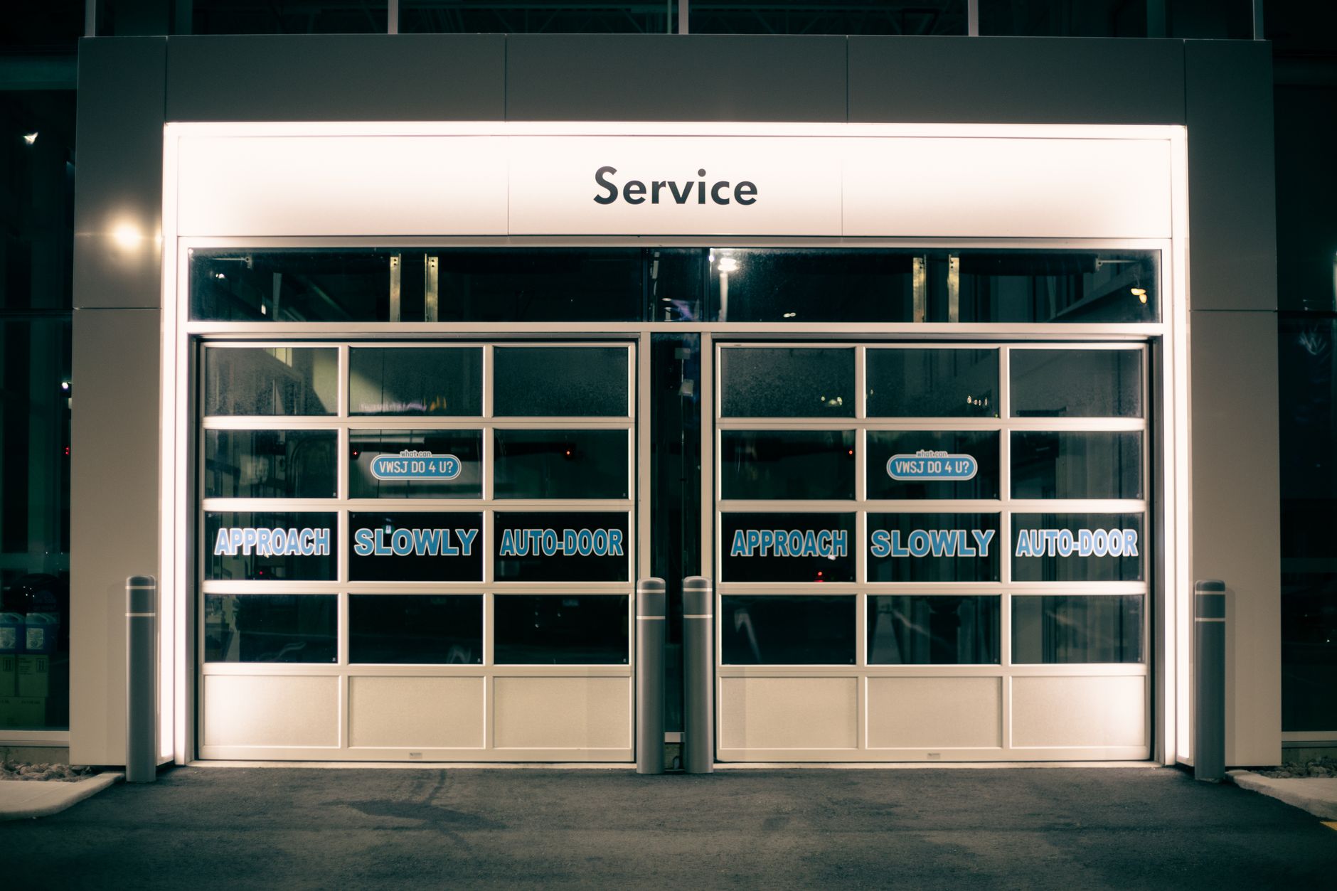 Sleek, automatic glass doors in a modern commercial building, representing an accessible entryway for autonomous robots.