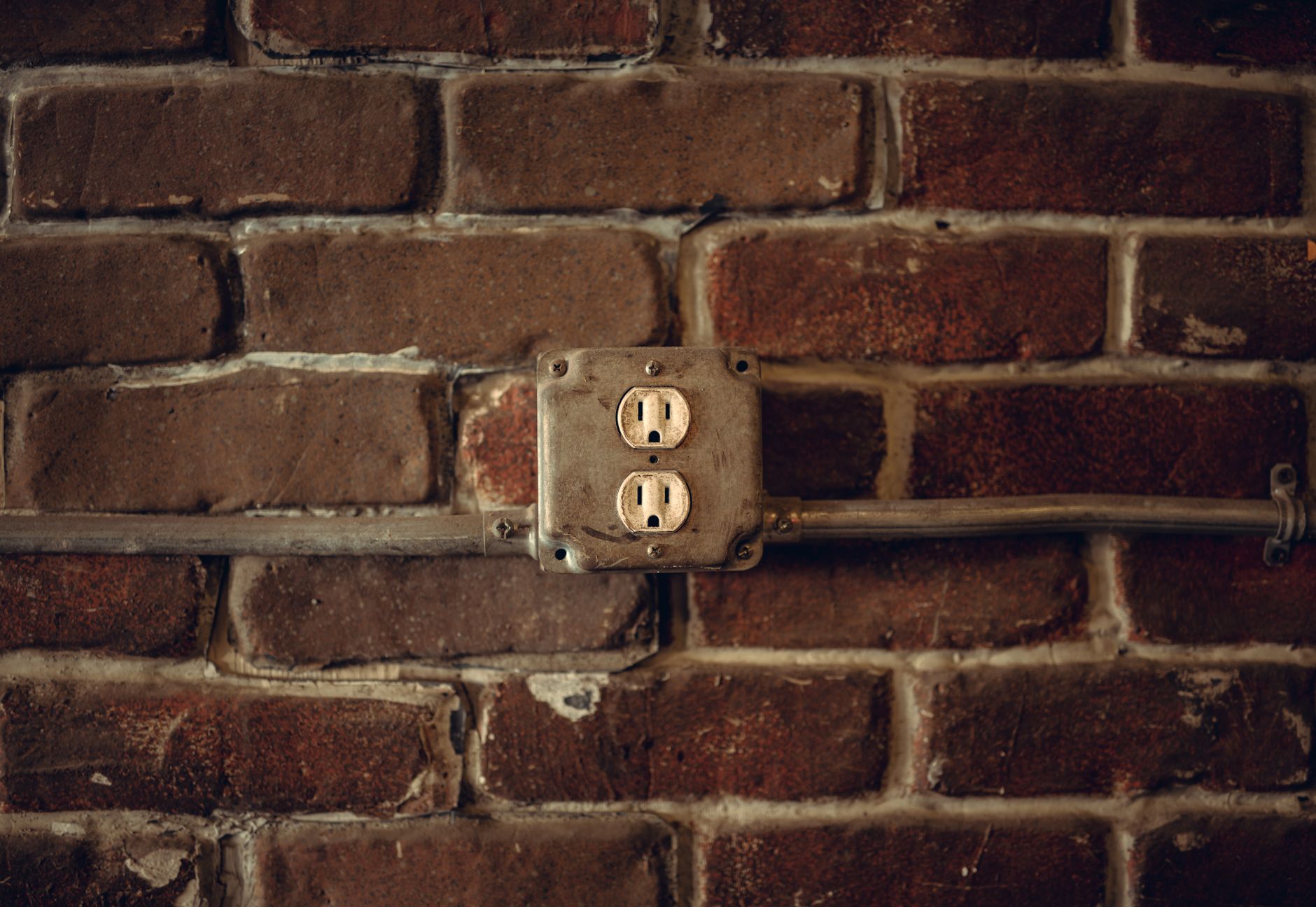 A series of electrical outlets mounted on a clean wall in a commercial facility, indicating the power infrastructure needed for robot charging stations.