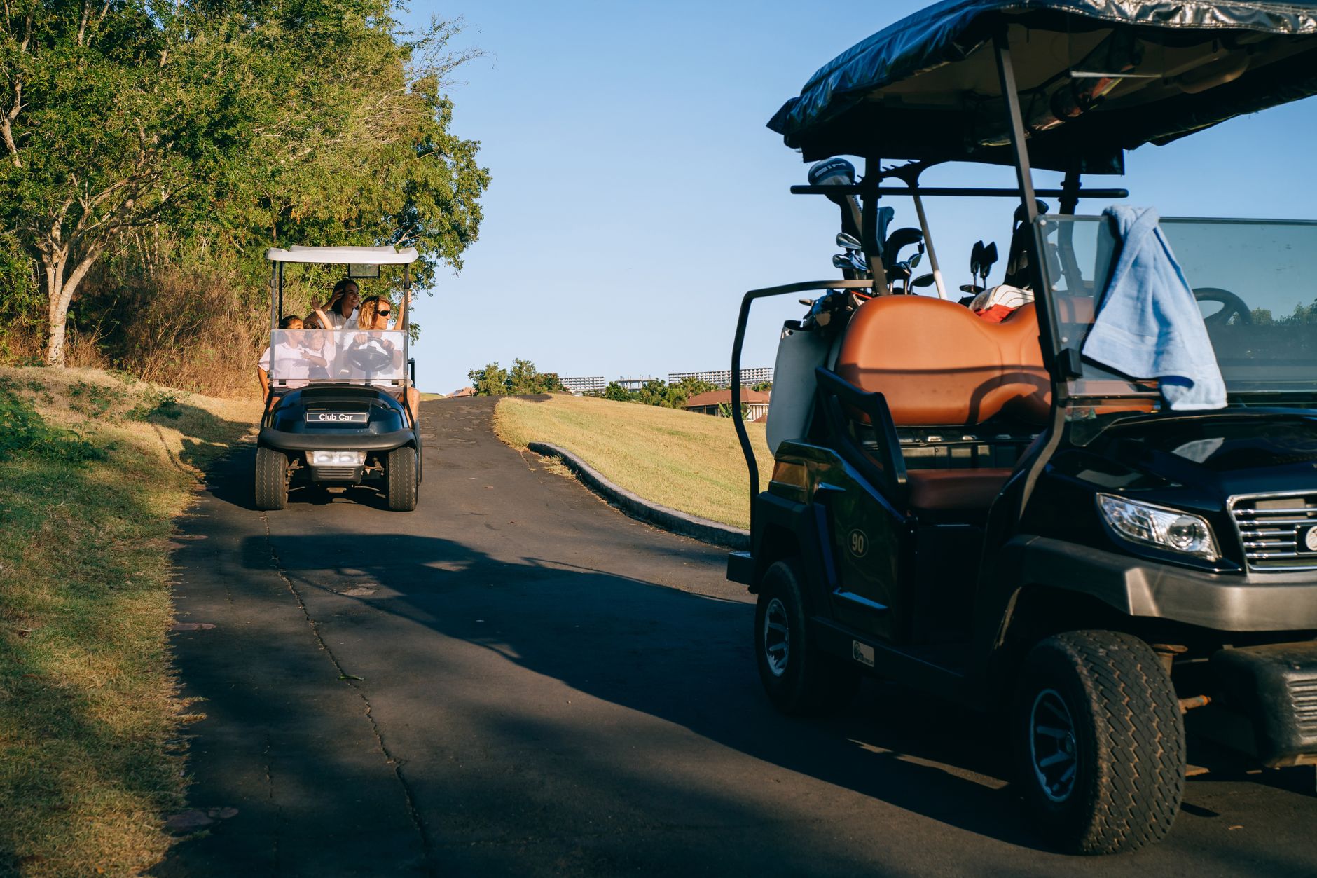 Cart path crossing near tree-lined golf holes