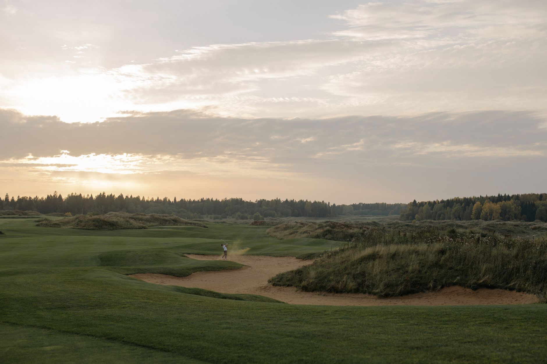 Wide golf fairway at sunrise before players arrive