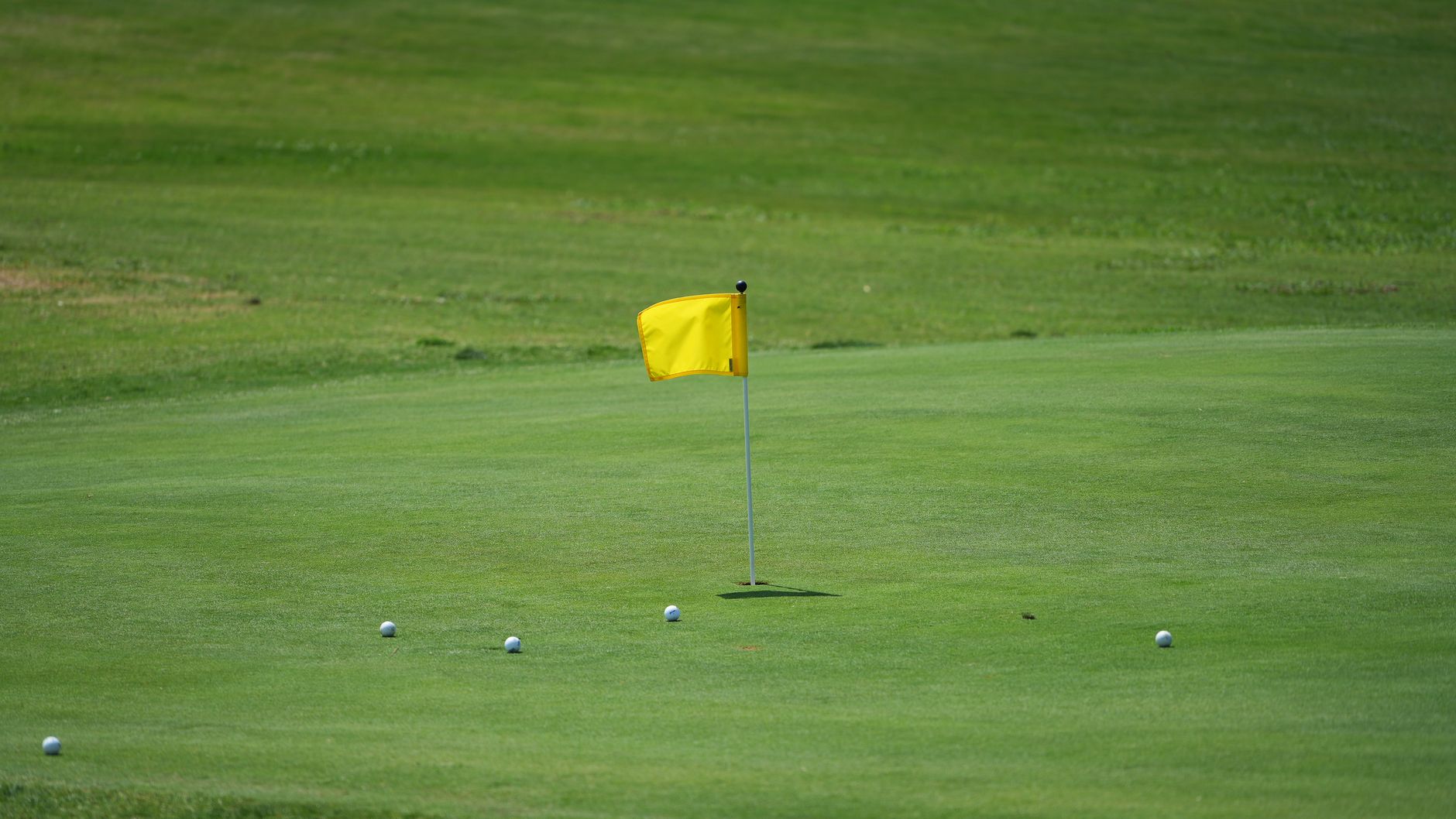 Flagstick on a prepared green, the kind of detail crews protect when fairway hours are freed for tournament prep.