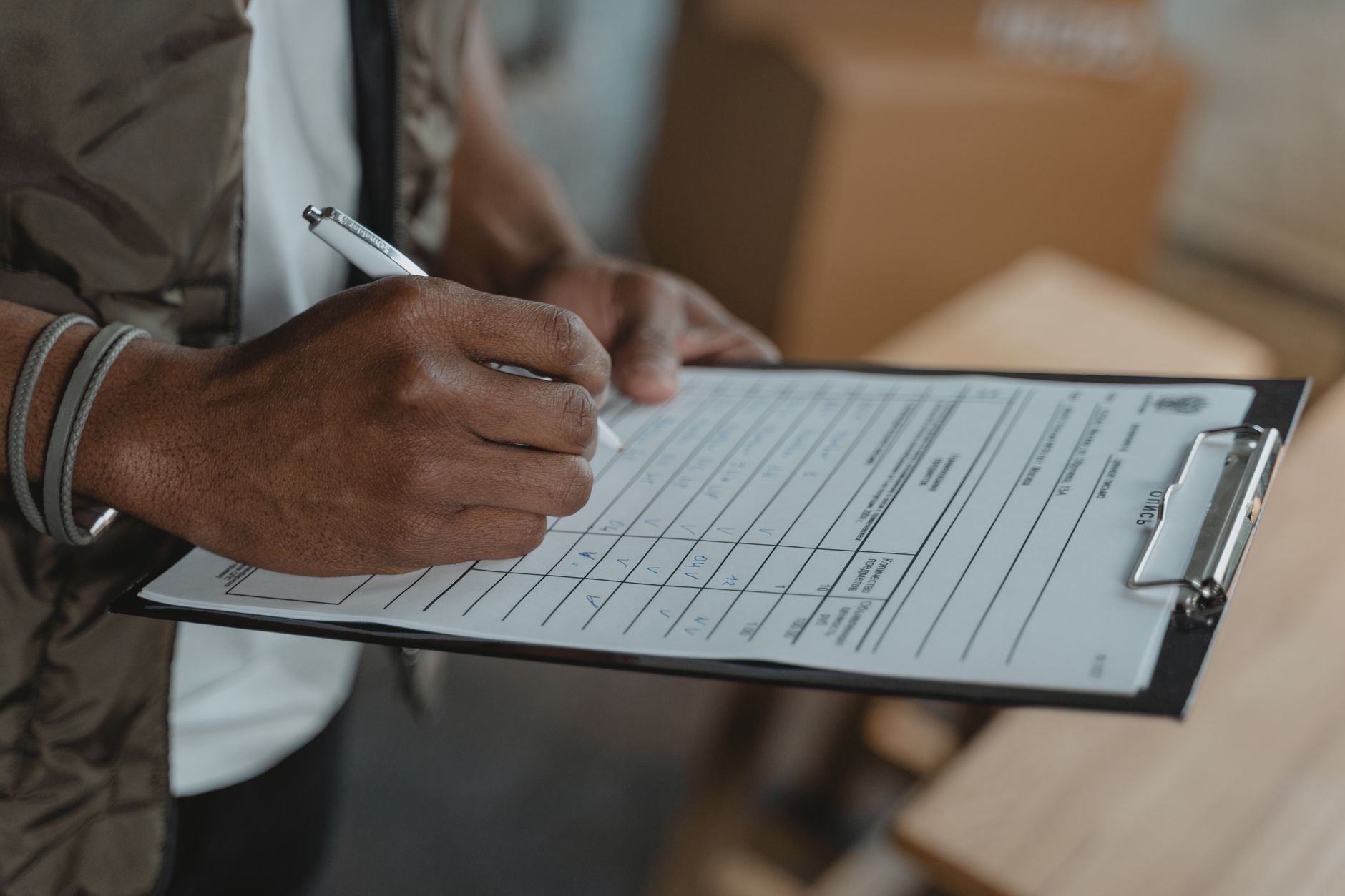 A maintenance professional reviews equipment records and inspection paperwork before a purchase.
