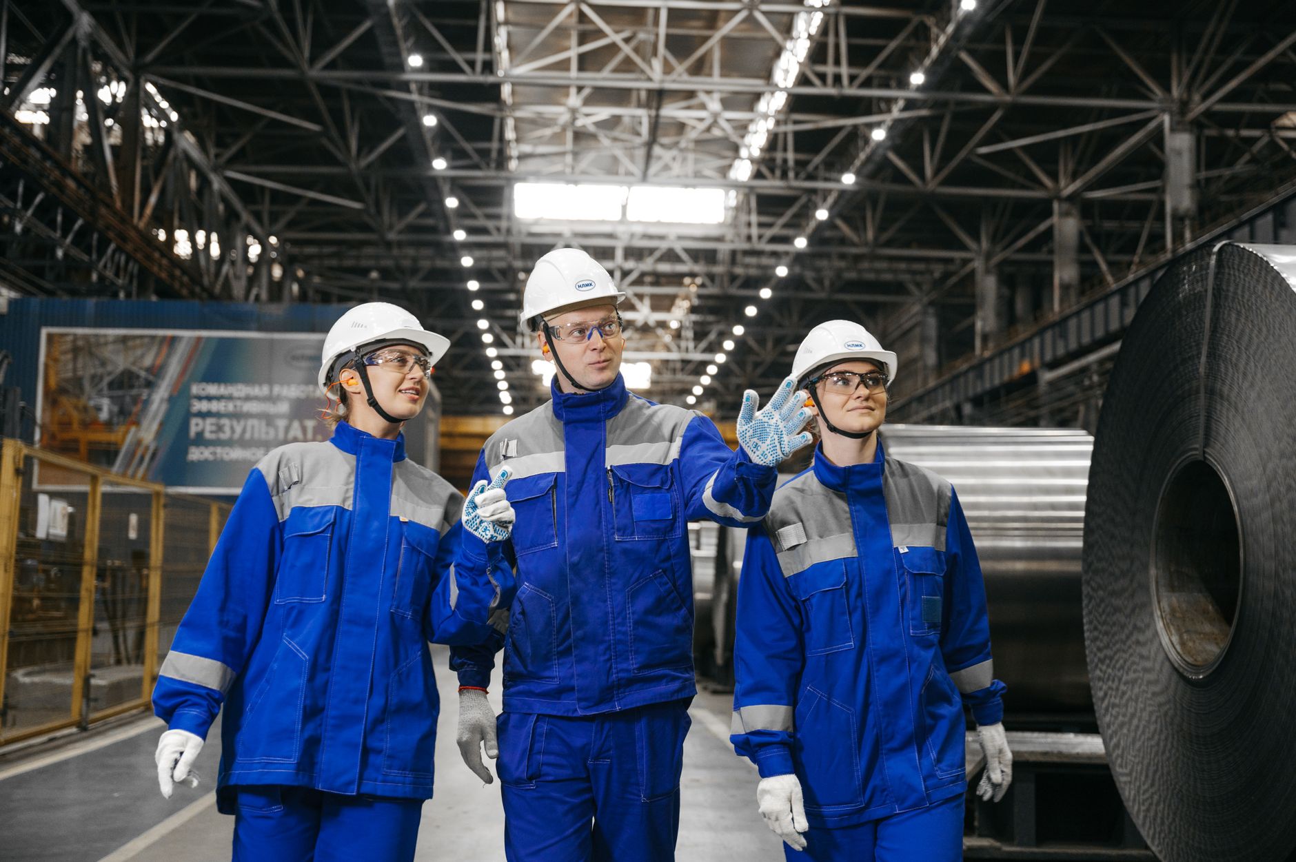 Safety manager in a hard hat walking a plant floor during an inspection
