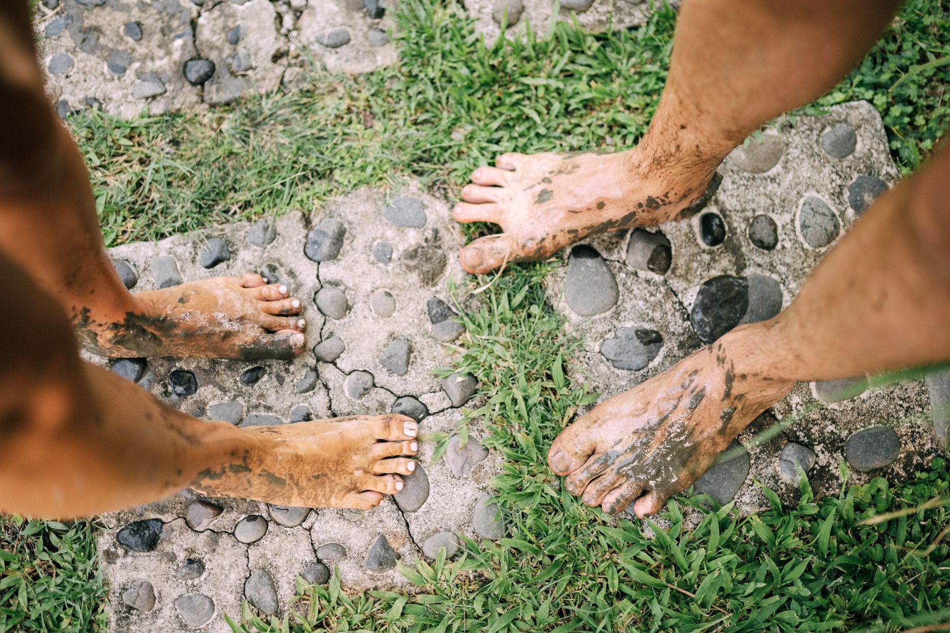 A deep footprint in soft turf showing soil moisture