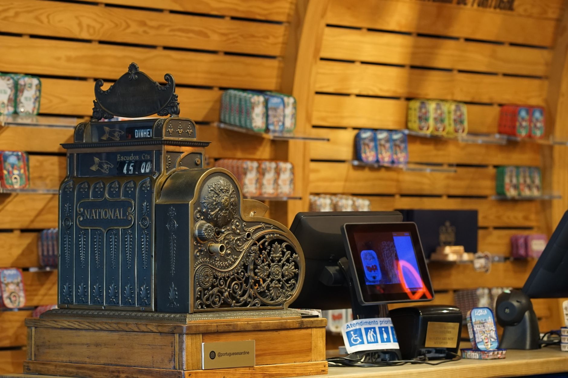 Convenience store checkout counter with snacks and coffee station nearby.