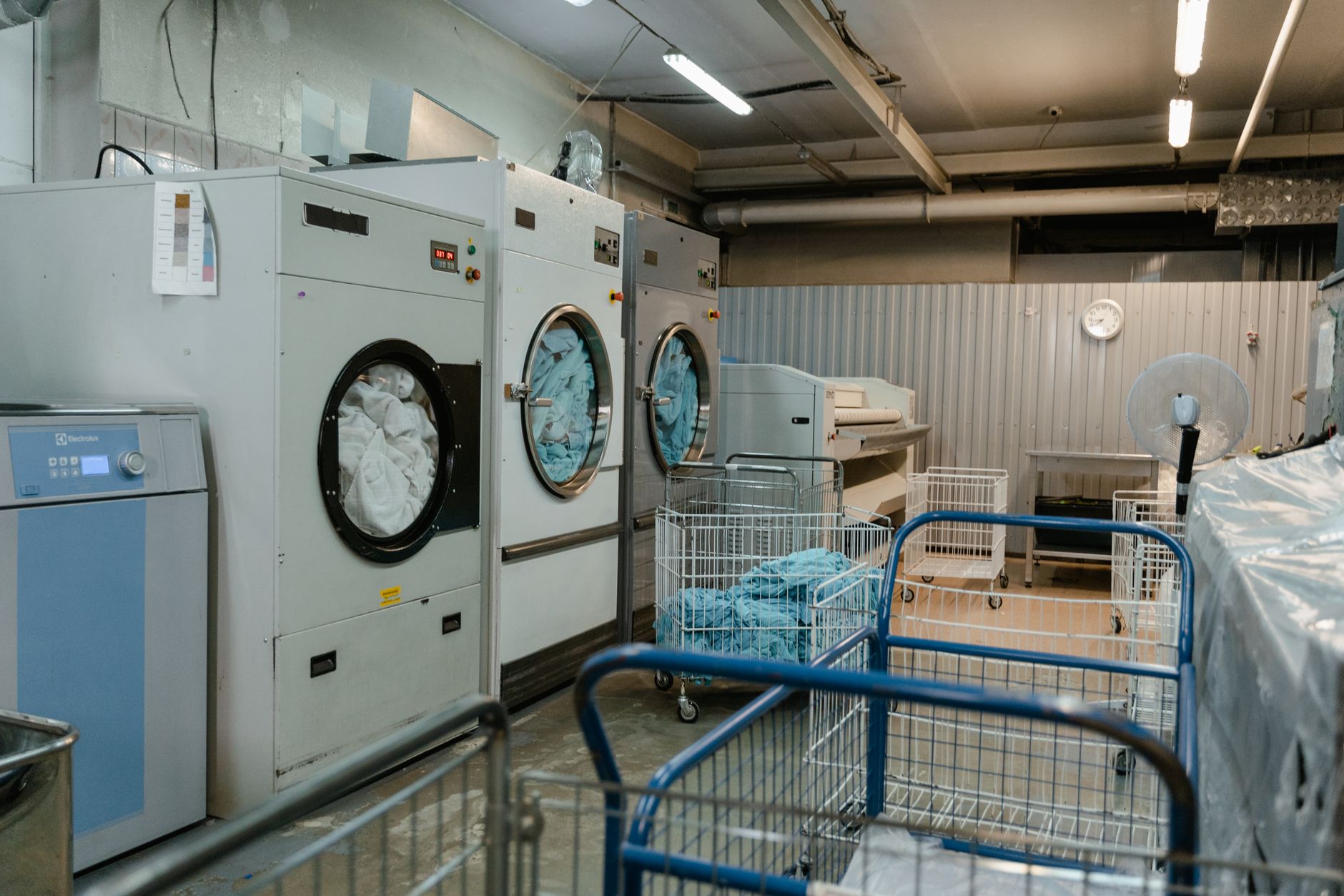 A hotel laundry or linen room prepared for turnover work, reinforcing the need for a clear fallback plan when service tasks revert to staff.
