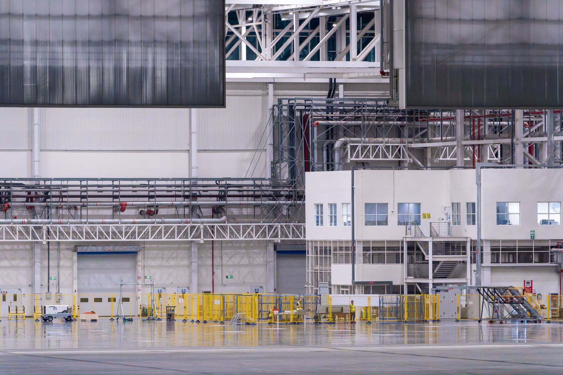 A sanitation worker washes down surfaces inside a food production facility.