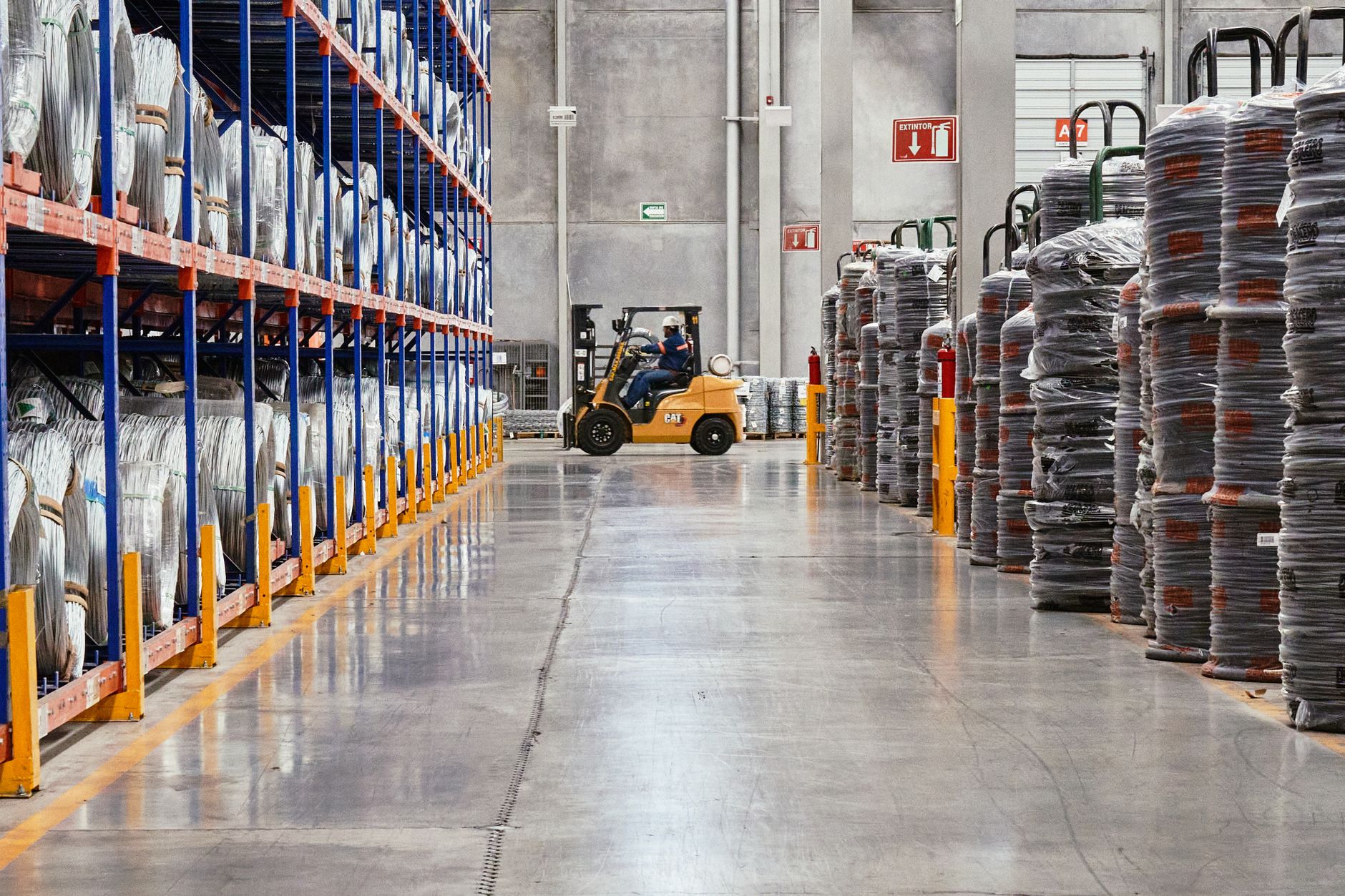 A forklift operates safely in a warehouse aisle, illustrating the importance of powered industrial truck training, a key focus of OSHA citations.