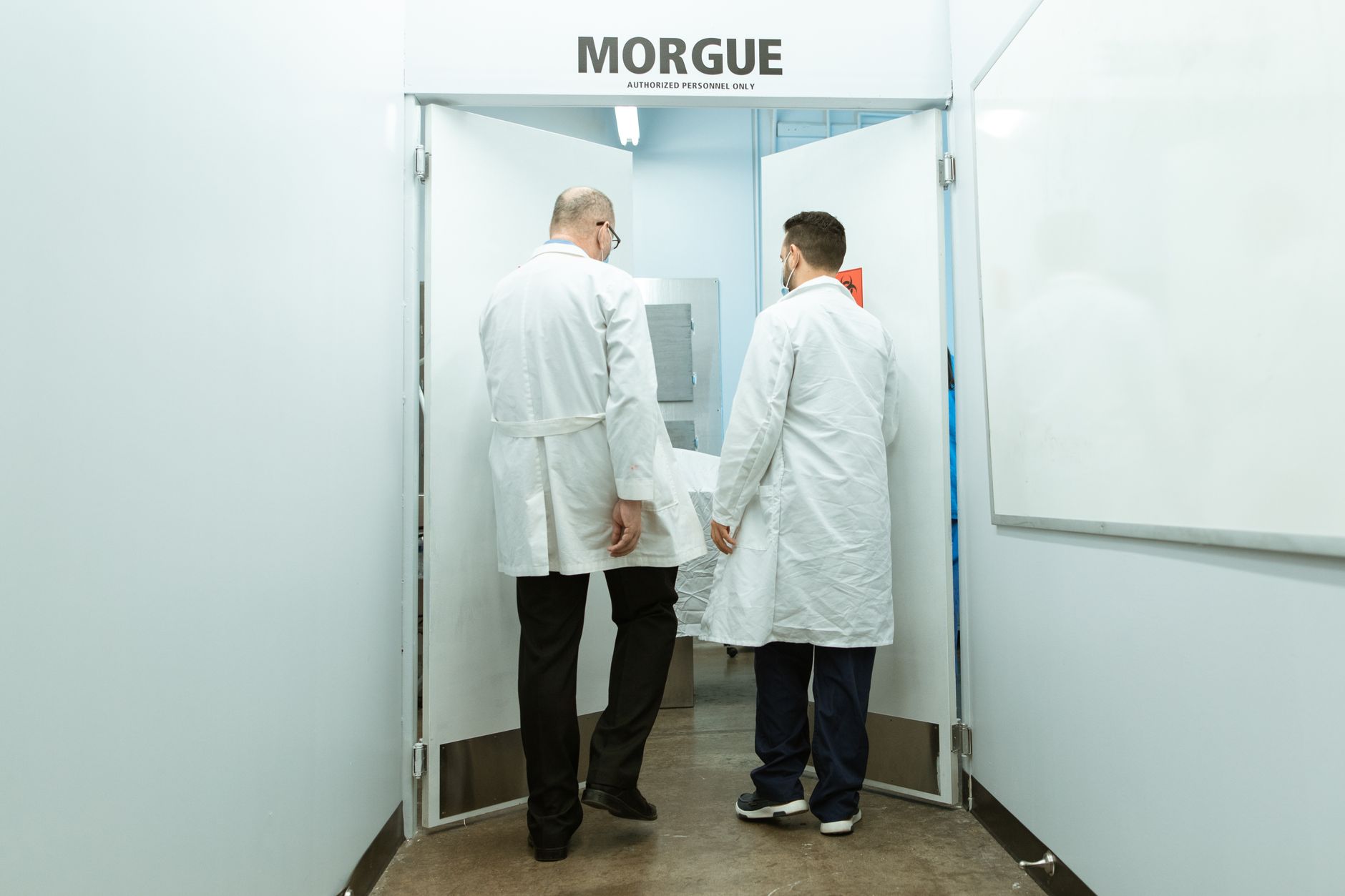 A hospital stretcher moving through a corridor, illustrating how patient transport depends on timing, handoffs, and readiness across departments.