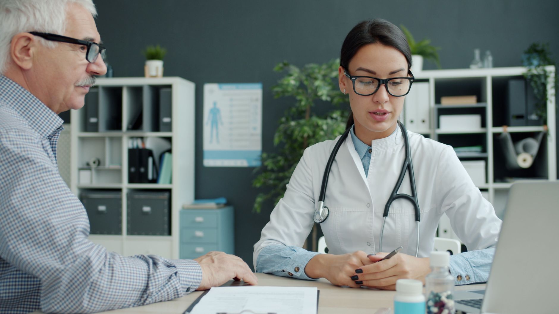 Professionals meeting around a table in a healthcare office