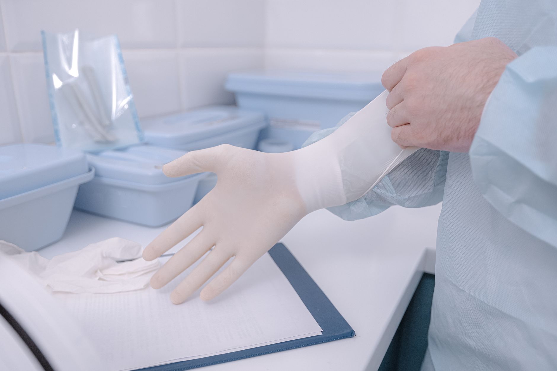 Gloved hands preparing supplies in a sterile medical environment