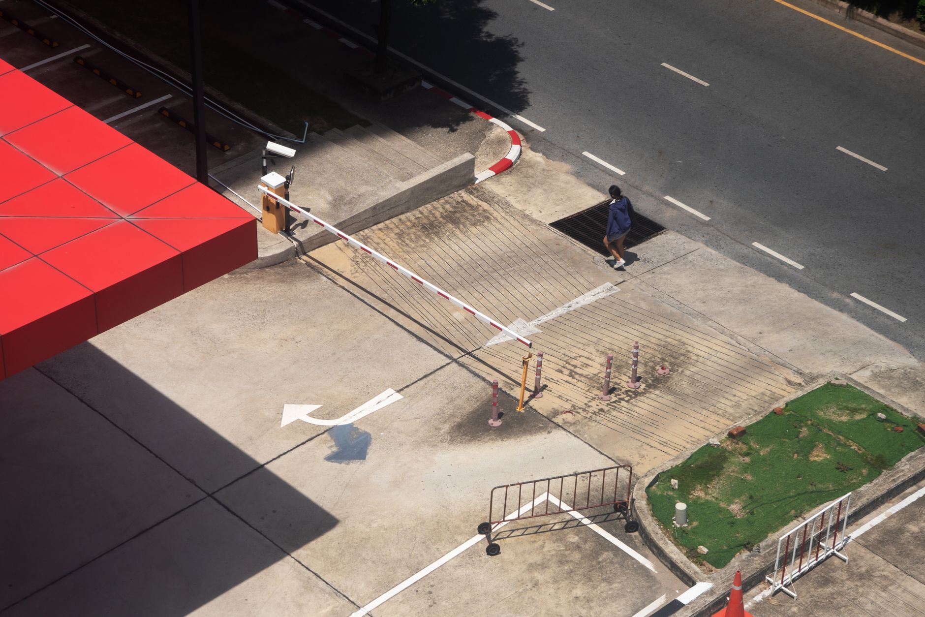 A curb ramp and crosswalk corner in a dense city setting, showing the kind of public-right-of-way detail operators must manage under permit rules.