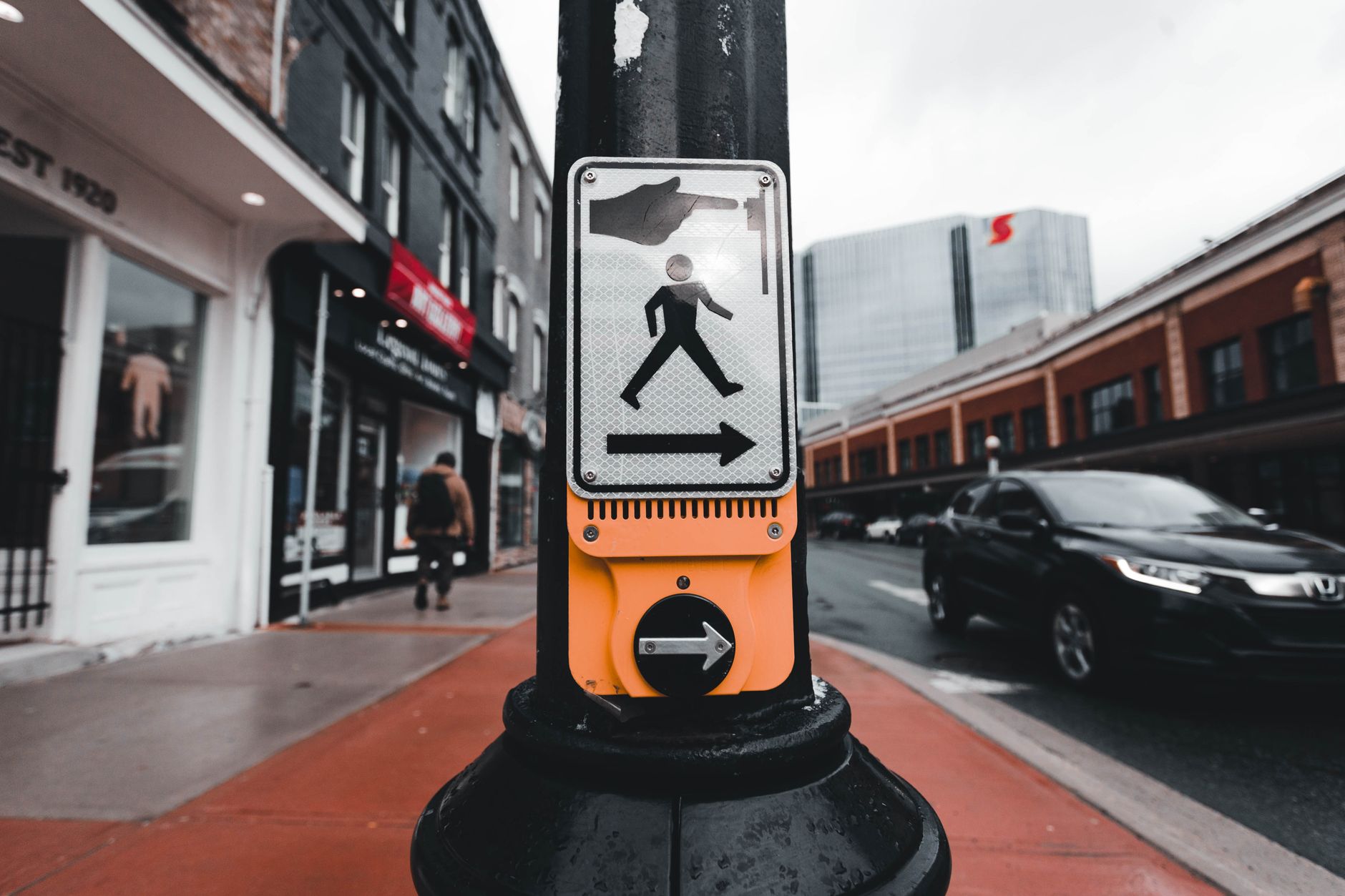 Downtown sidewalks and crosswalks in Washington, D.C., illustrating the public-space routes that robot deployments must now plan around.