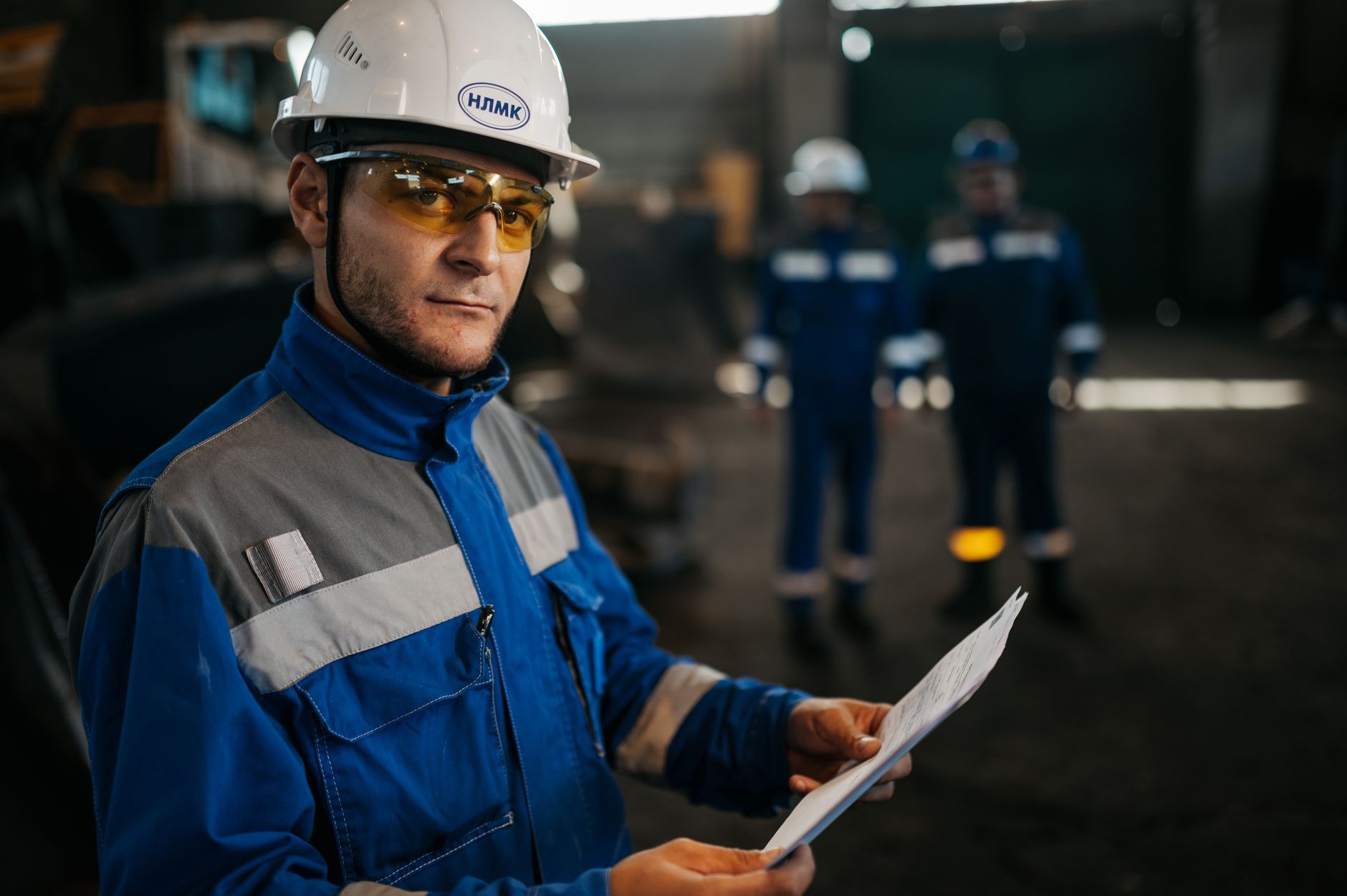 A technician inspects equipment during a route through an industrial facility.