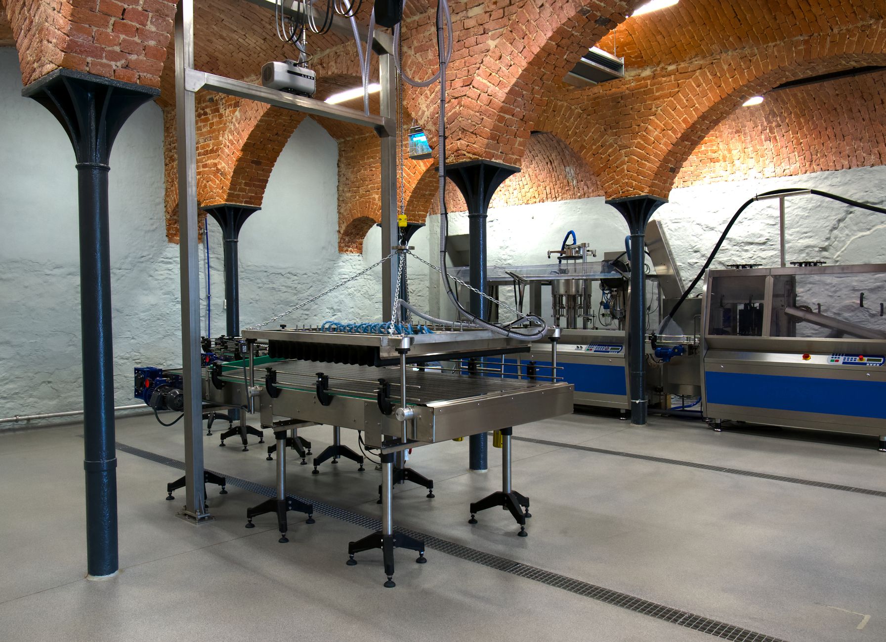 The interior of an industrial facility, representing the complex operational environment where a unified, multi-vendor robot fleet must be integrated.