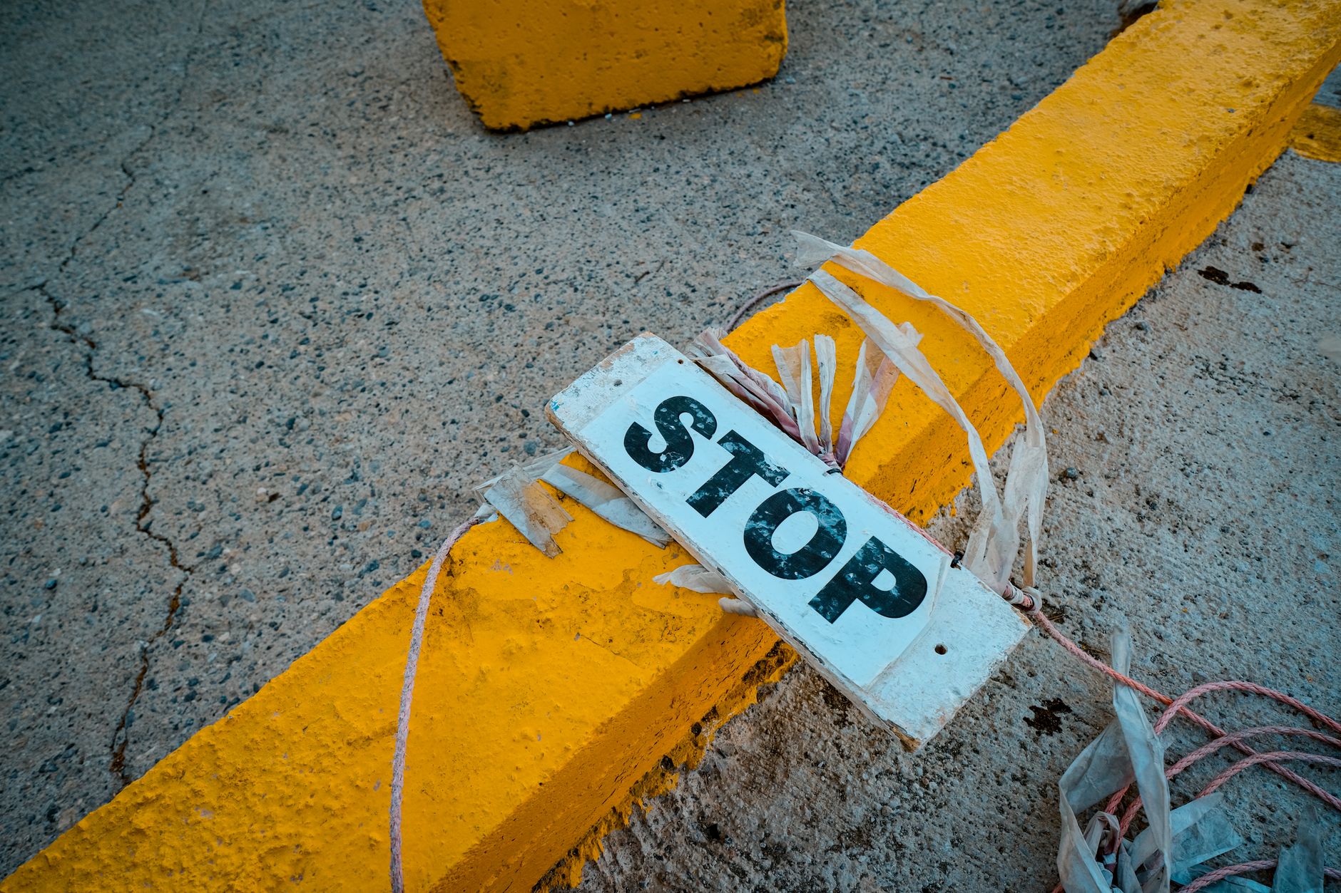 A yellow caution sign on a wet floor in a large, empty commercial space, signifying that normal operations are paused.
